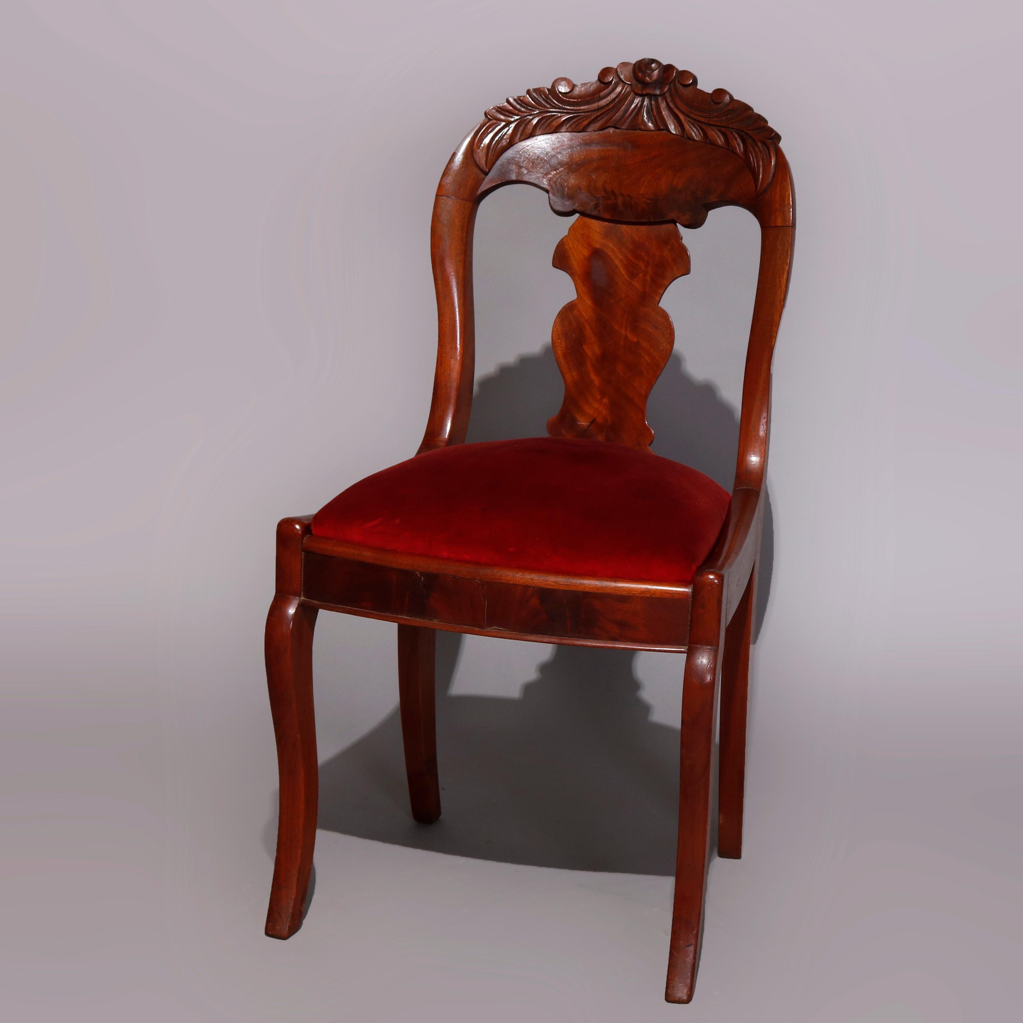 A set of six antique American Empire dining chairs offer flame mahogany construction in gondola form having carved foliate crests surmounting stylized urn form slat backs, upholstered seats, raised on cabriole legs, circa 1840

Measures: 33.5