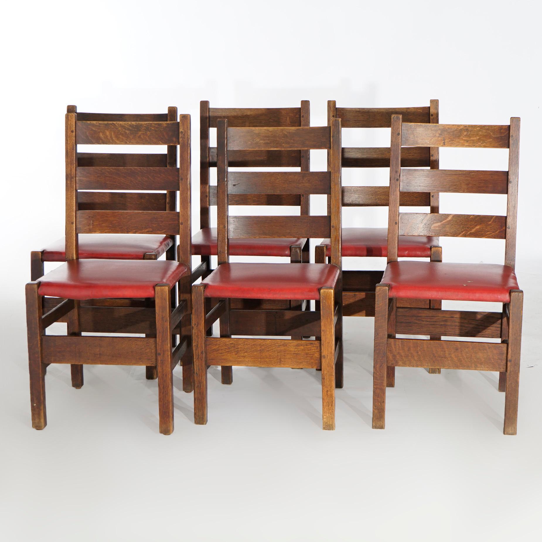 An antique set of six Arts and Crafts dining chairs by Gustav Stickley (Catalog #208) offer quarter sawn oak ladder backs over upholstered seats and raised on square and straight legs, unsigned, c1910.

Measures- 36''H x 17''W x 21''D.