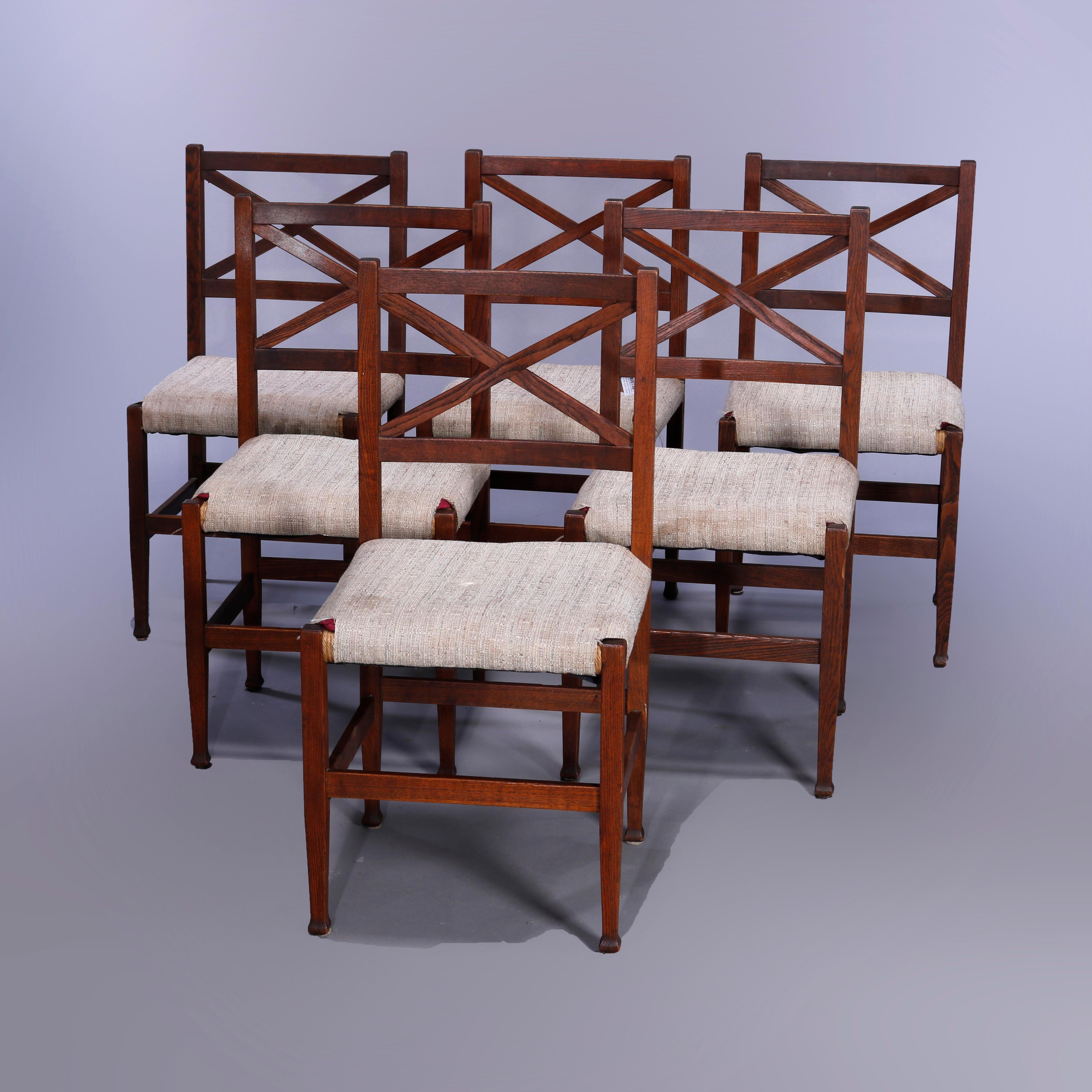 A set of six arts and Crafts Mission dining chairs in the manner of Brooks offer oak construction with x-backs over upholstered seats, c1910

Measures - 36.5''h x 18.25''w x 18''d; seat height 19.25''.