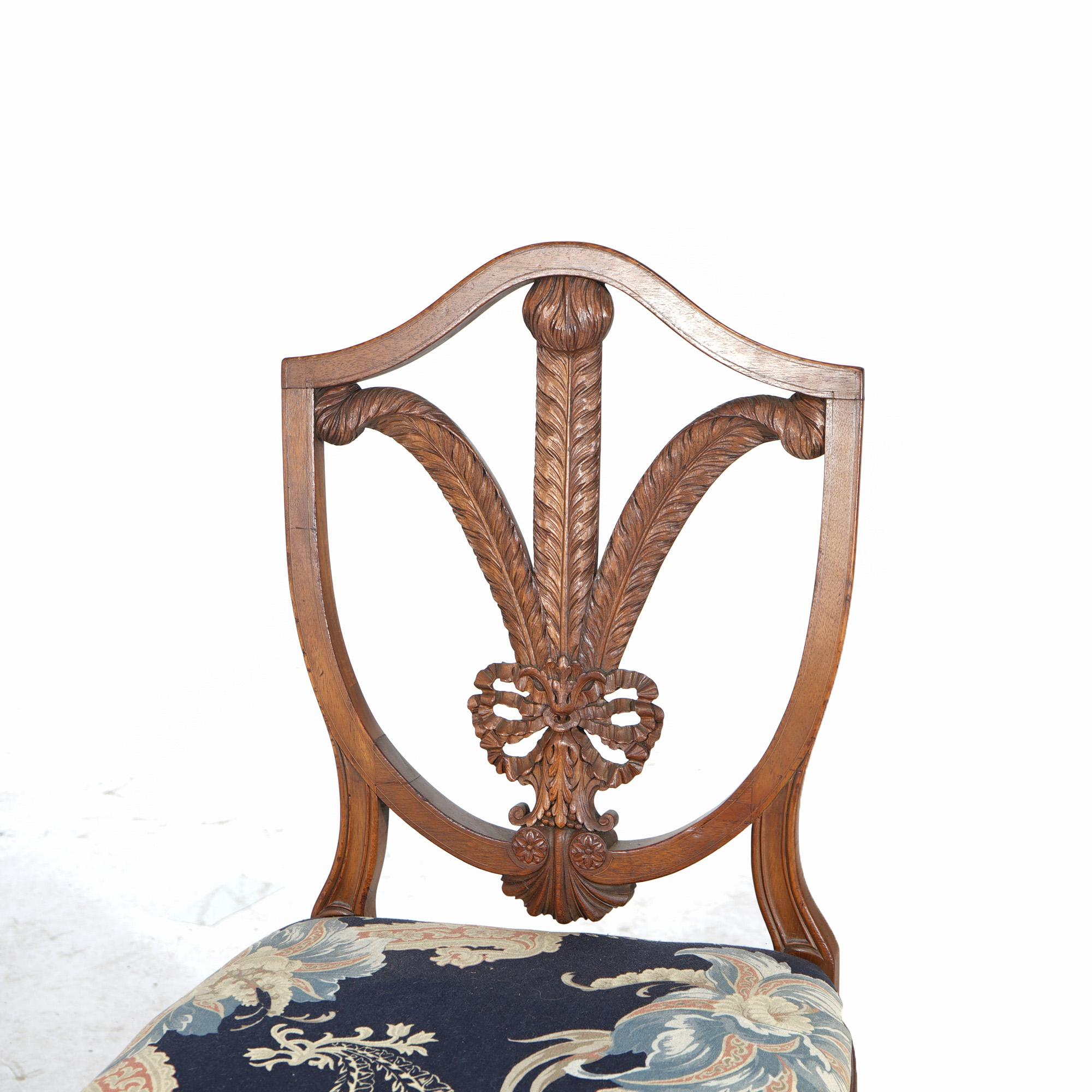 ***Ask About Lower In-House Shipping Rates - Reliable Service, Competitive Rates & Fully Insured***
An antique set of six dining chairs offer mahogany construction with shield backs having wheat form splats over upholstered seats, raised on tapered