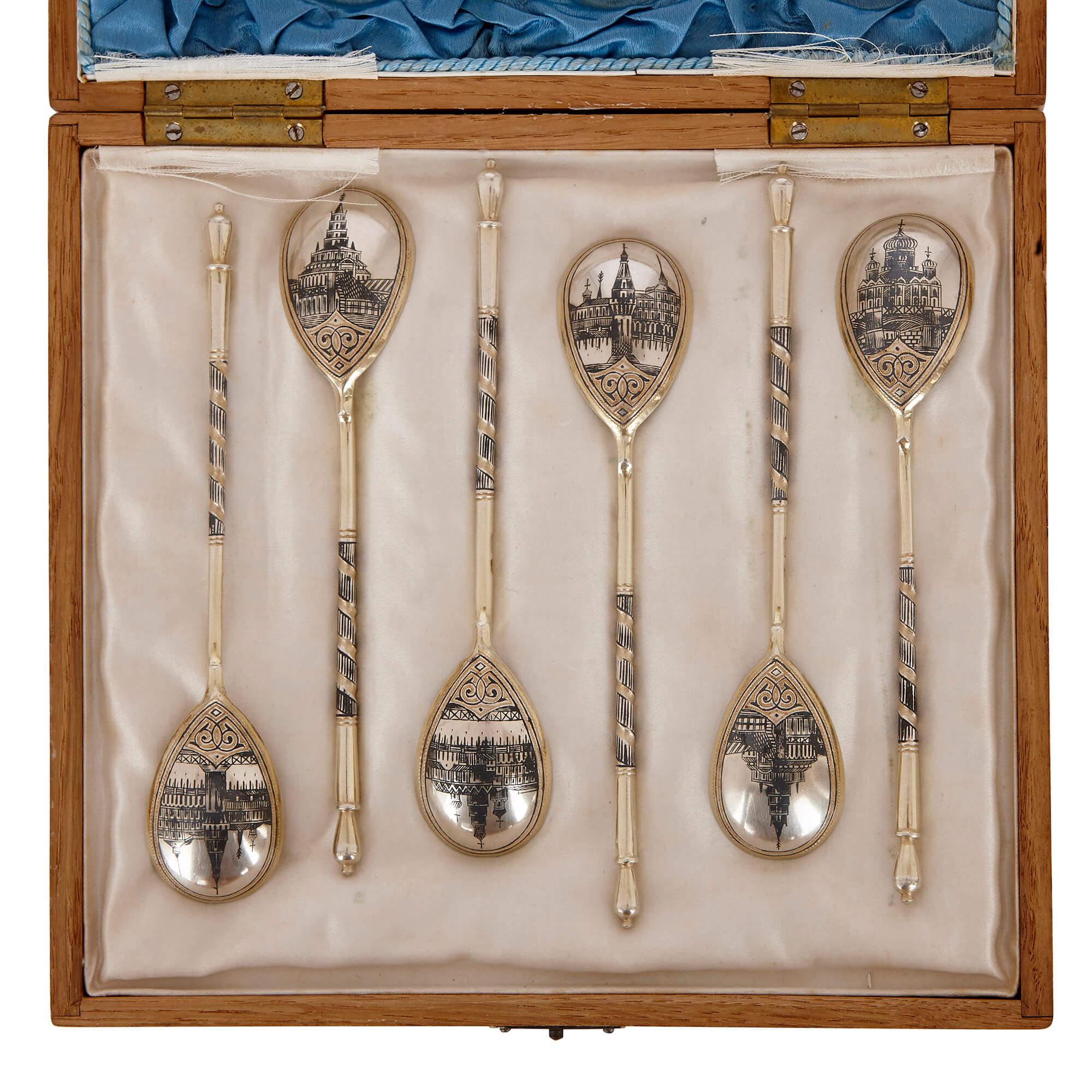 This Fine set of six silver-gilt spoons is distinctive for the intricate niello designs that decorate the back of each bowl. 

The back of each spoon bowl has been engraved with the image of a Russian building. These incised lines have been filled