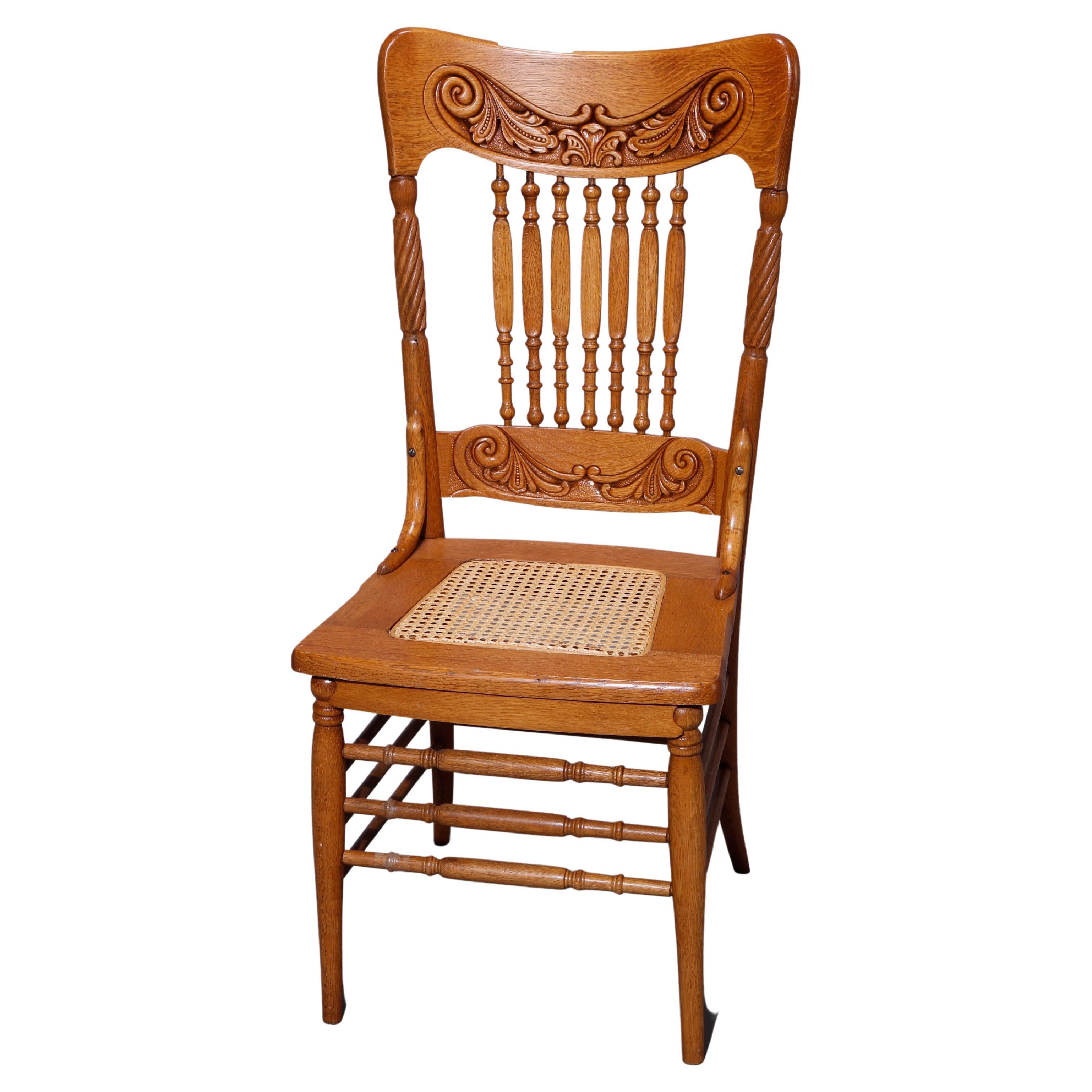 A set of six antique dining chairs offer oak construction with backs having scroll and foliate pressed back rails over spindles flanked by rope twist supports over pressed cane seats, raised on turned legs having triple stretchers, c1910
Measures -