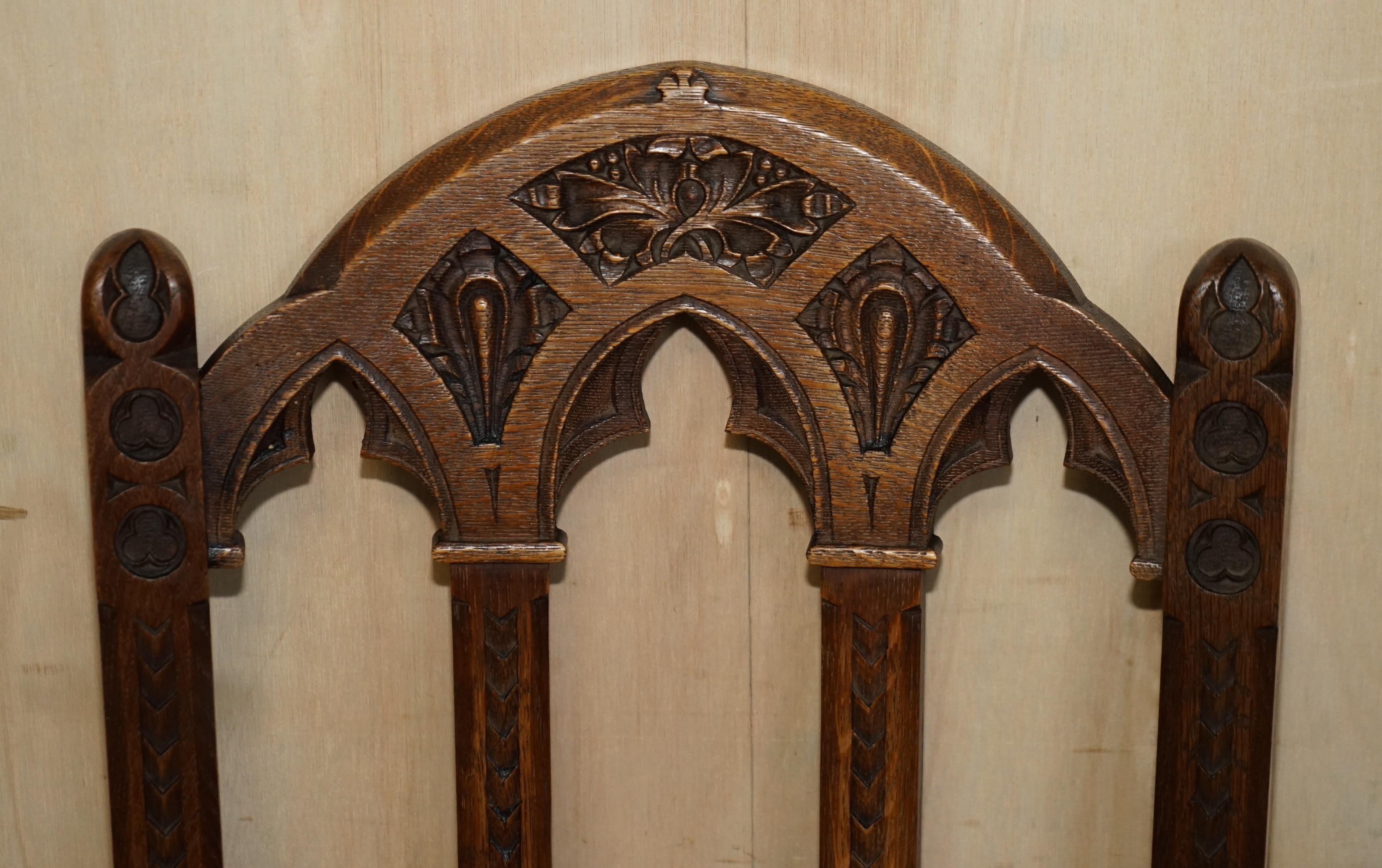 Hand-Crafted SIX ANTIQUE ORNATELY CARVED STEEPLE BACK WALNUT GOTHIC REVIVAL DiNING CHAIRS For Sale