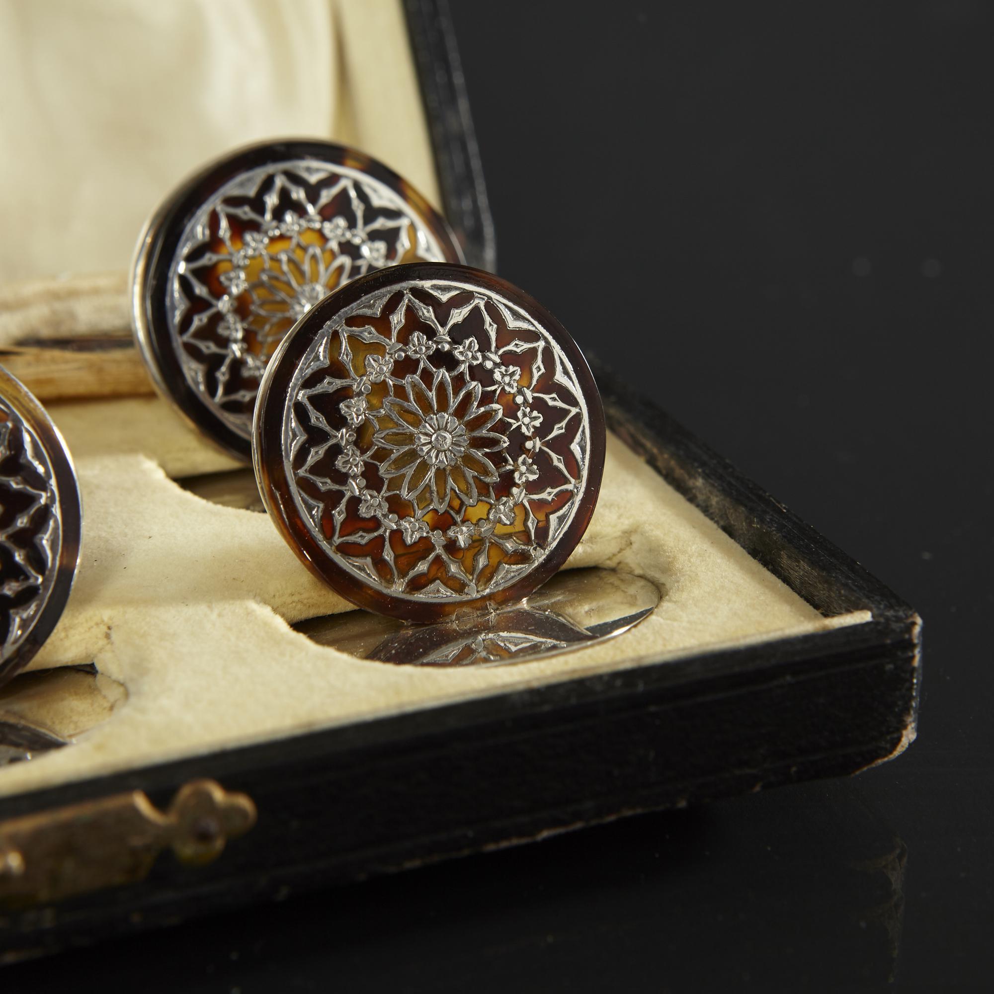 An exquisite set of 6 silver and tortoiseshell menu or place card holders decorated in the Arabesque style. Each card holder is a circular disc with the finest and most intricate inlay of silver set into the tortoiseshell. They are in superb