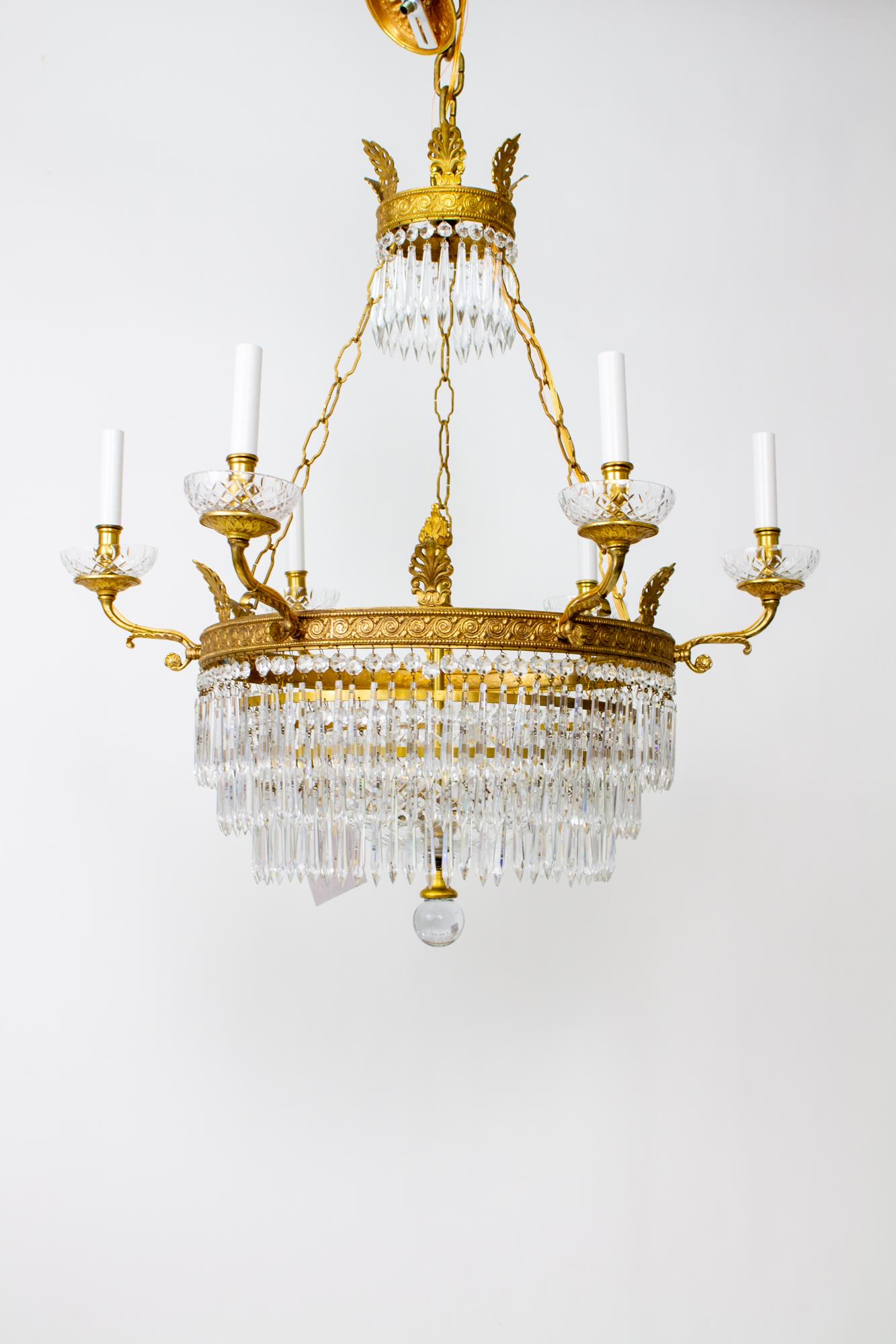 European Six Arm Brass and Crystal Empire style Chandelier For Sale