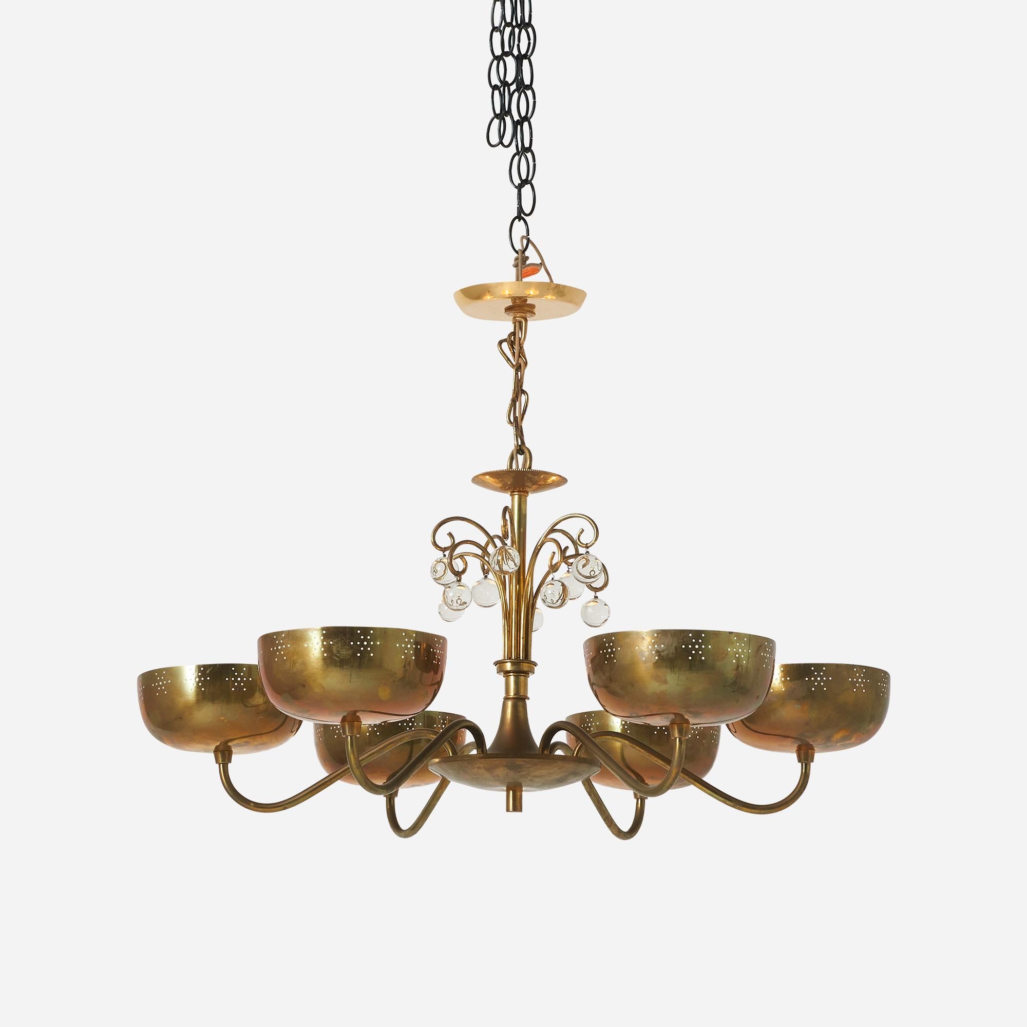 A brass chandelier with 10 hanging crystal orbs and 6 cupped arms. Attributed to Lightolier and creation attributed to Paavo Tynell.