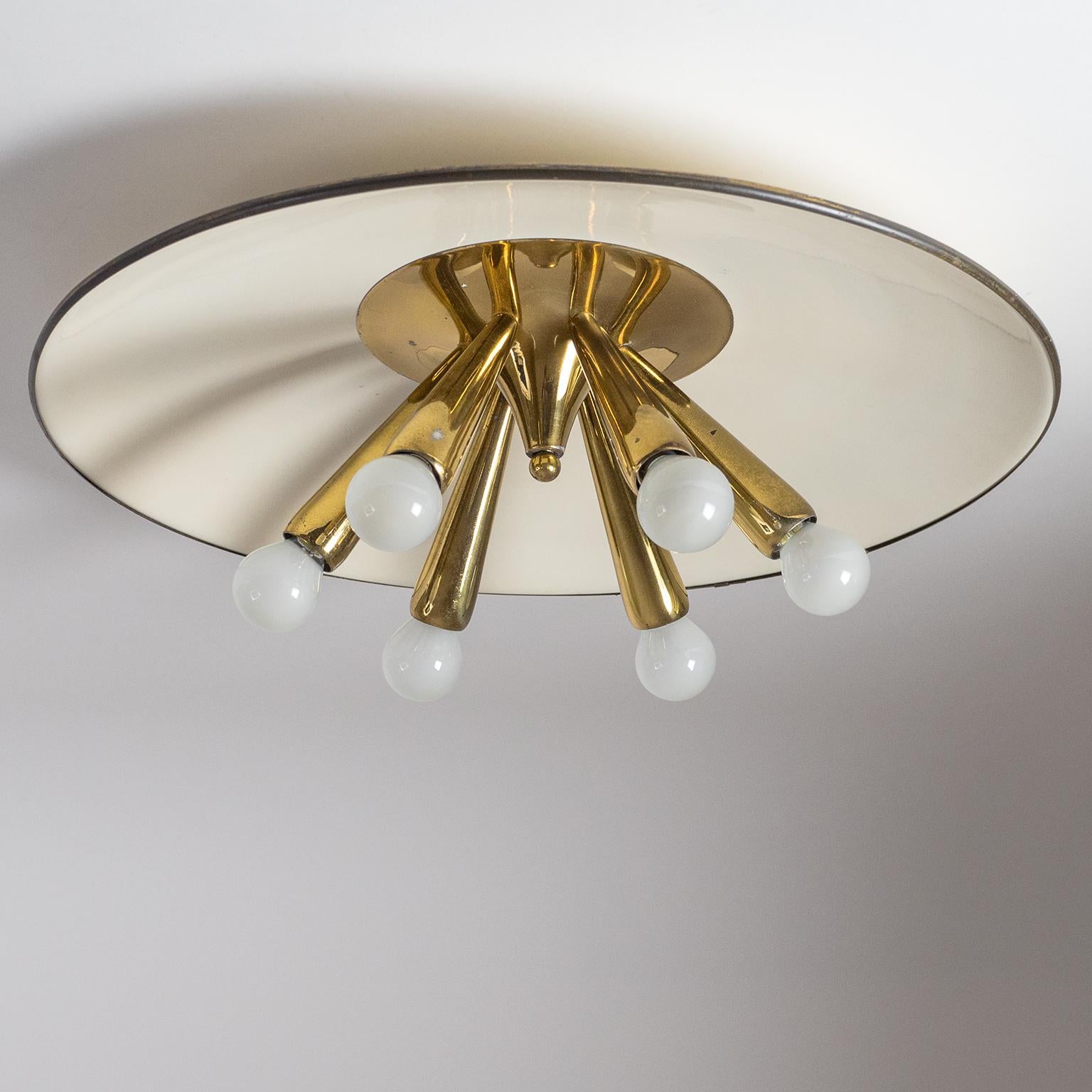 Large 1950s flush mount with six brass arms and a large off-white lacquered shade with brass rim. Fine original condition with patina on the brass and minor wear to the lacquered shade which has a glossy finish. Each arm has an original brass E14