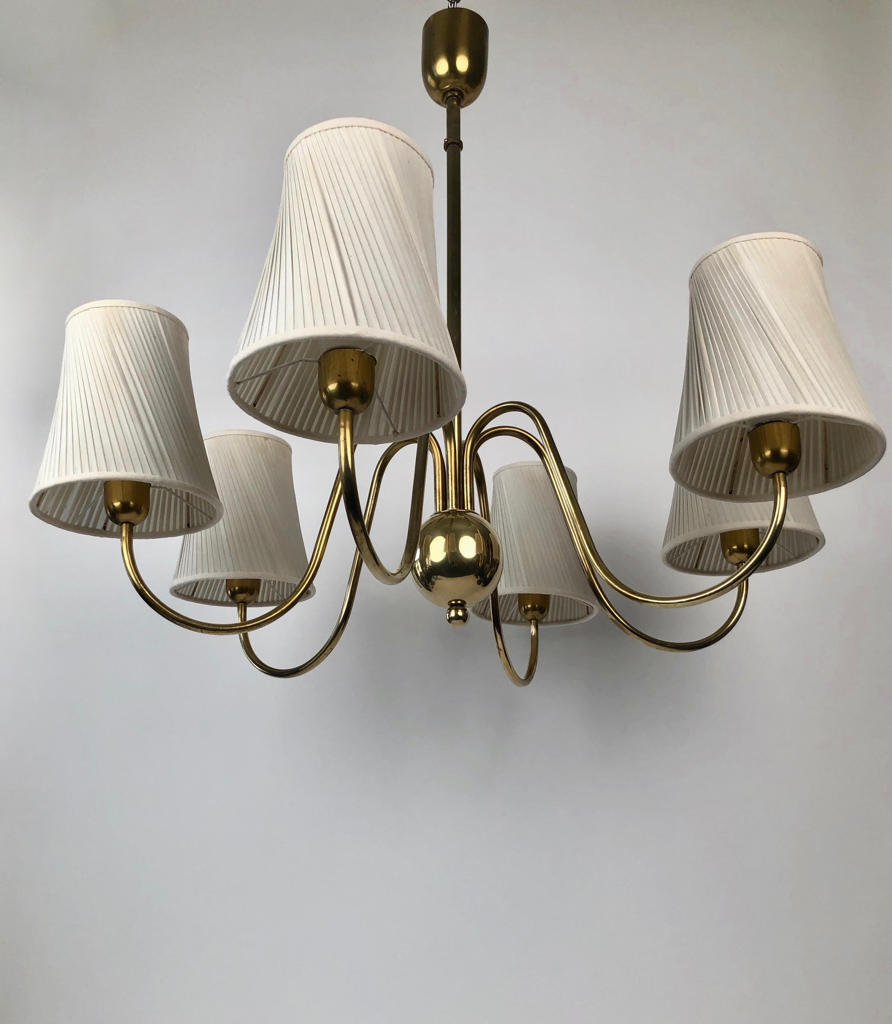 Six arm chandelier from Josef Frank from the 1930's. The shades are original with new pose met . The electric has been controlled. There is a patina on the still and canopy.
The canopy is slightly creased but dose not affect its use or aesthetic .