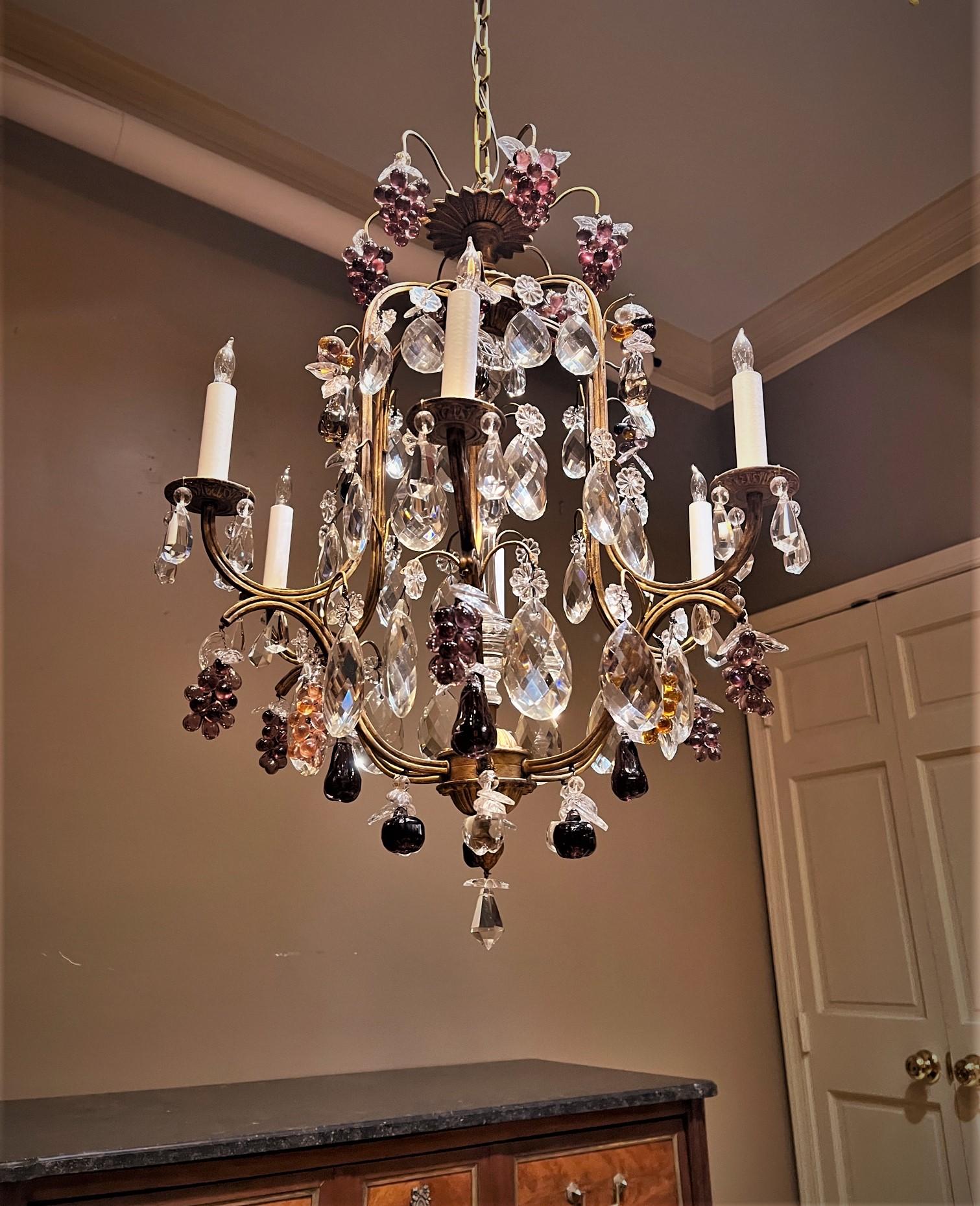 This Louis XV style chandelier is a real beauty destined to be the elegant focal point of any room. The hand wrought Rococo frame is made of gilt brass, the crystal is hand cut and molded. The crystal fruit is molded in purple and amber. Ceiling