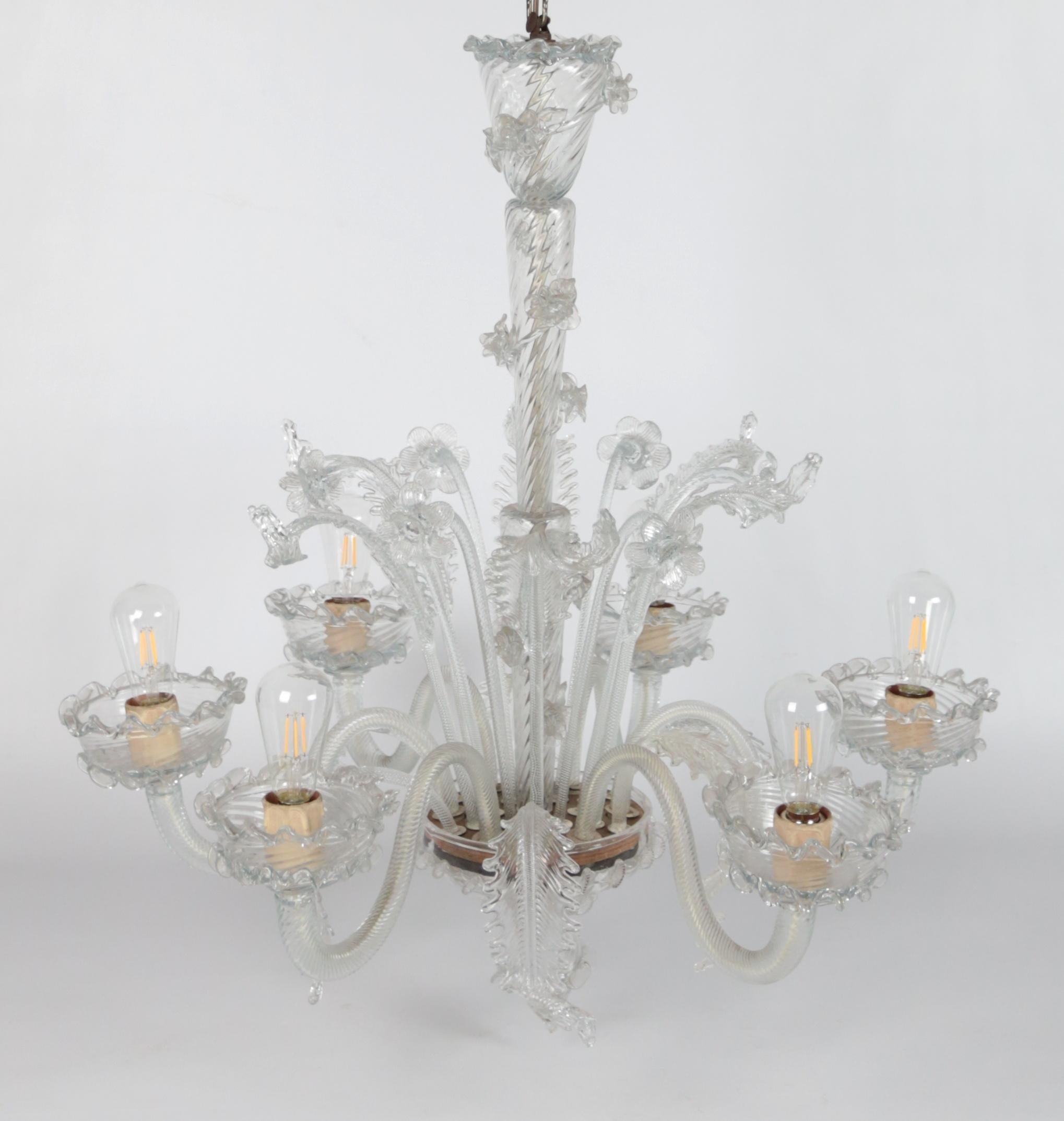 Six-arm Venetian Murano chandelier. Restored

Beautiful Venetian Murano chandelier with floral decoration. The chandelier has new wiring and a new power cable. Very good condition with no broken pieces. The chandelier is made of hand-cut glass.