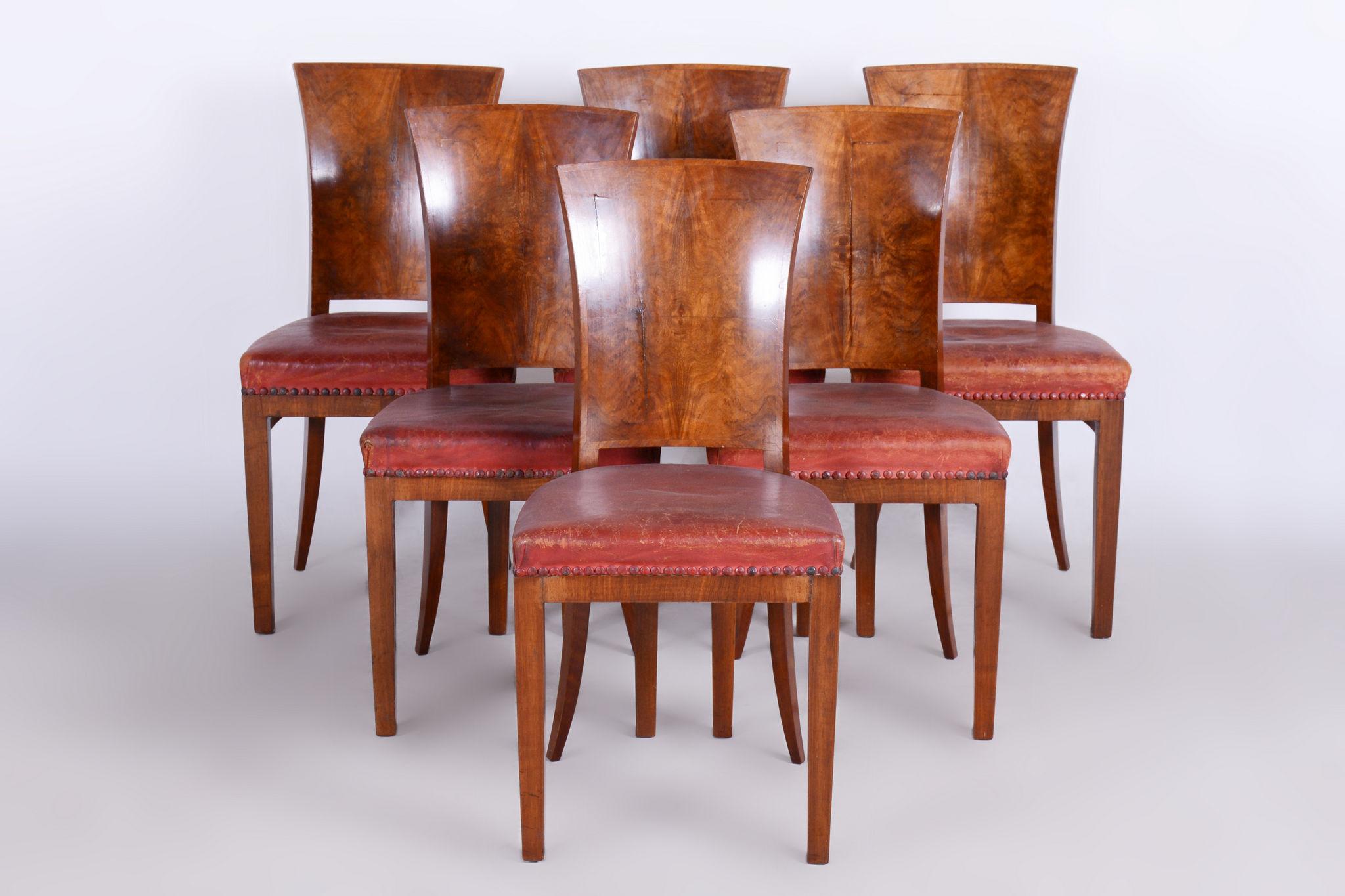 Six Art Deco chairs

Origin: France 
Period: 1920-1929
Material: Walnut, red leather, original upholstery

In pristine original condition, the upholstery has been professionally cleaned, and its polish revived by our refurbishing team in Czechia.