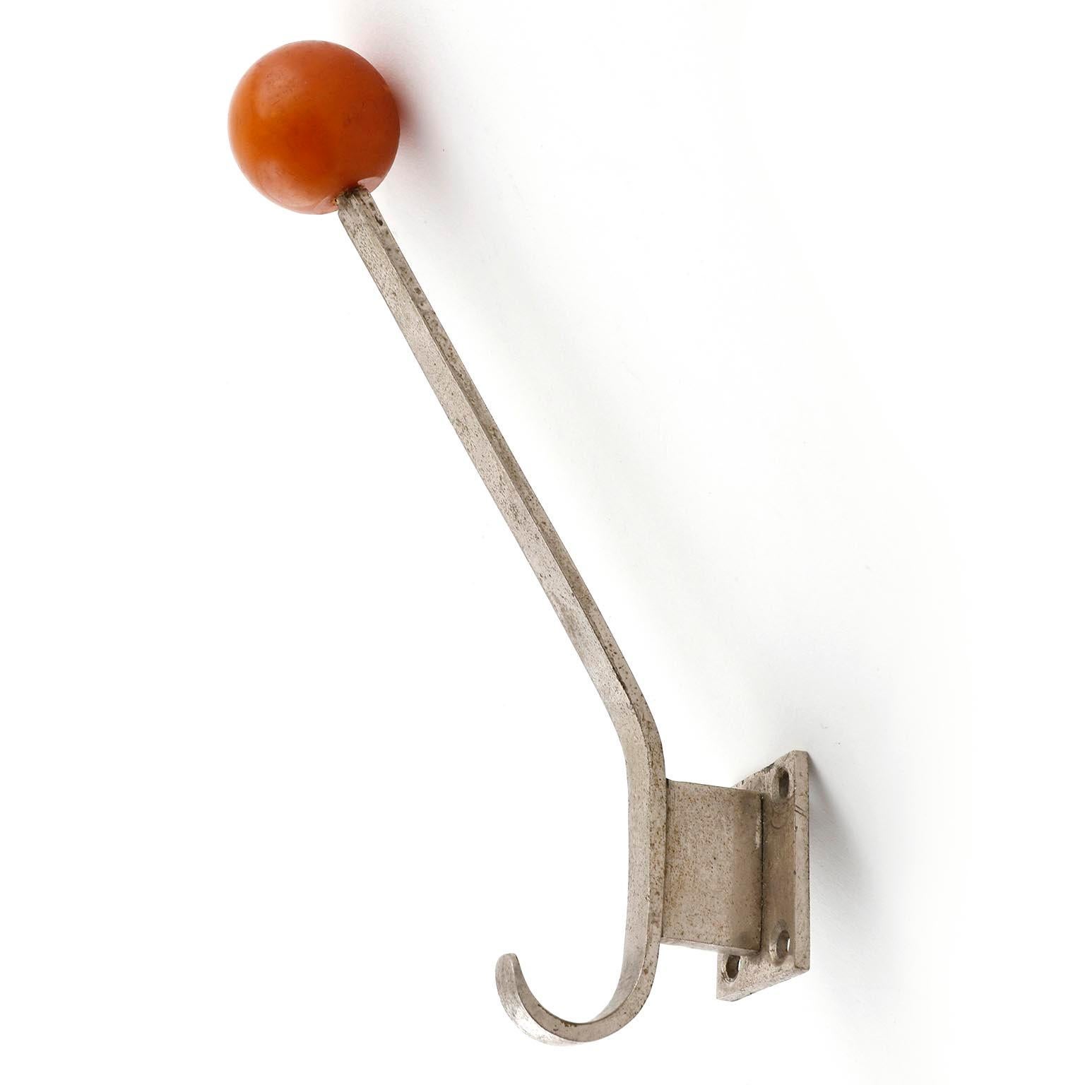 A set of six handmade Art Deco wall hooks, manufactured in Vienna, Austria, circa 1930. 
They are made of nickel-plated brass with red bakelite balls. They are in good condition with nice patina on nickel.
  