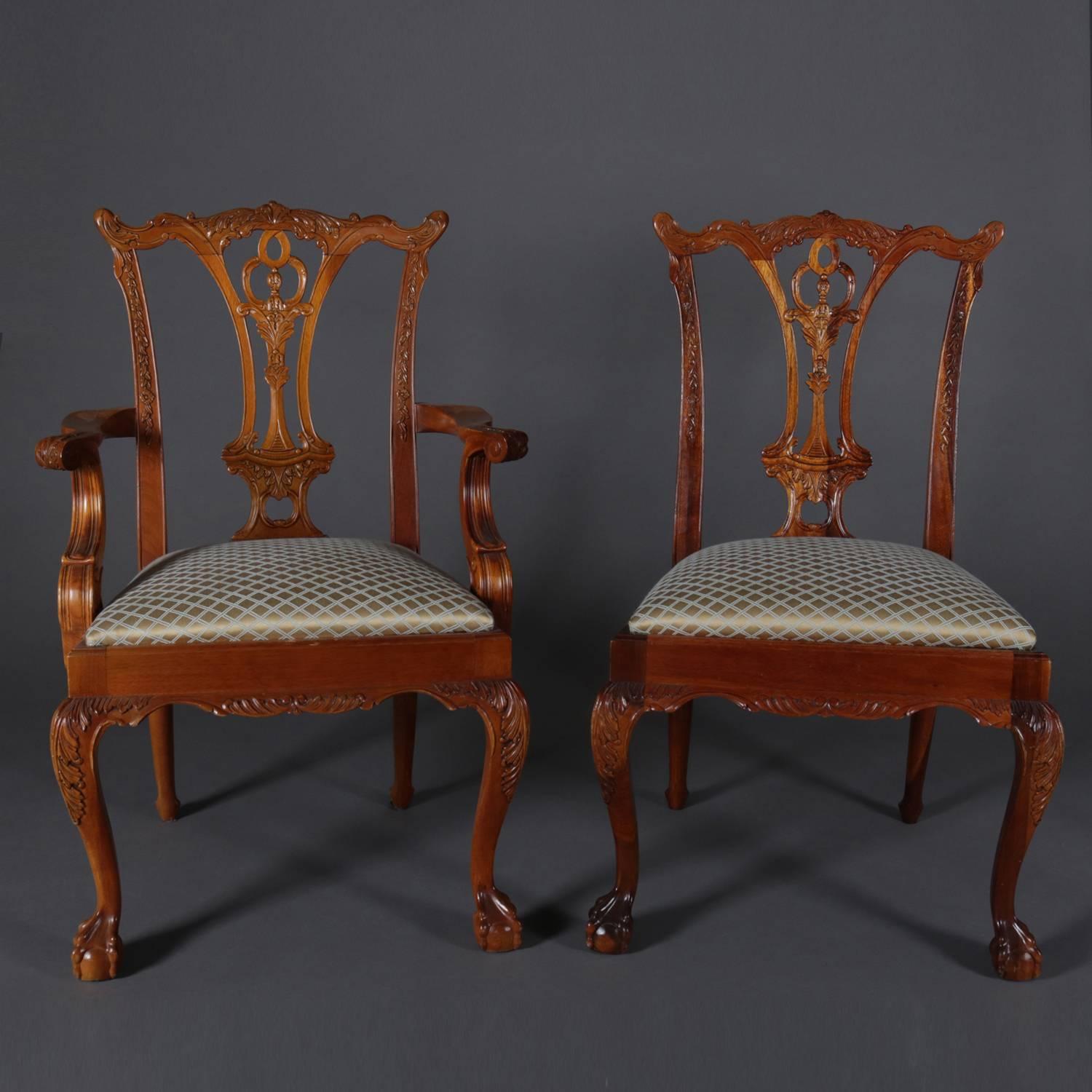 Set of six Chippendale style Baker School dining chairs feature carved foliate ribbon backs, upholstered seats, raised on cabriole legs with acanthus carved knees and terminating in carved claw and ball feet, includes one arm chair and five side