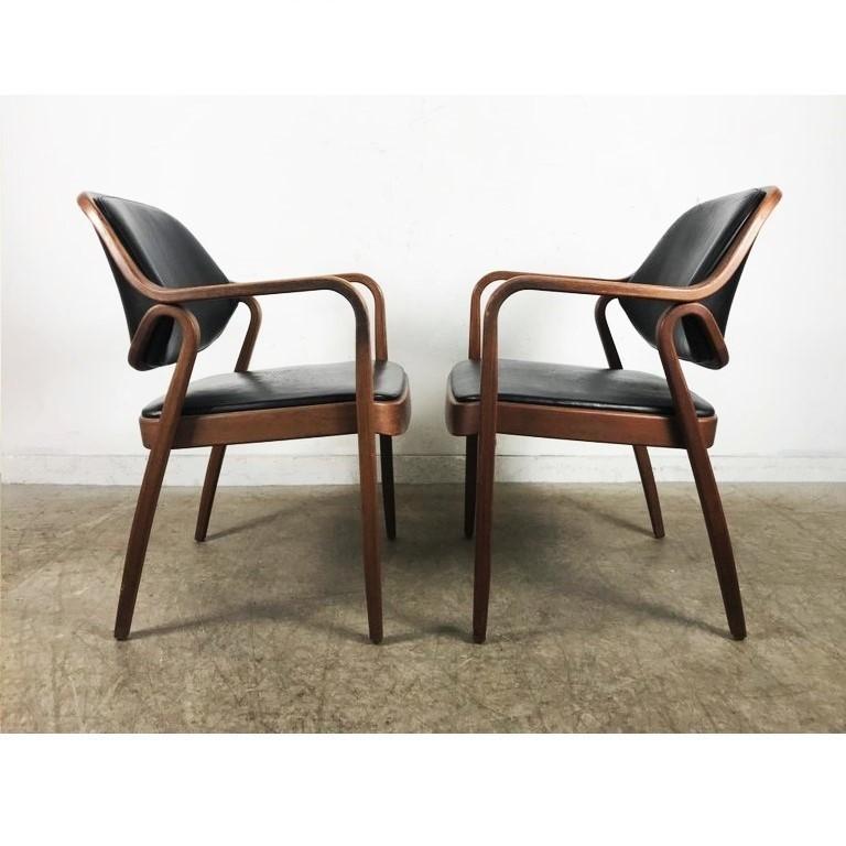 Bentwood armchairs by Don Petitt for Knoll. Two lengths of pressed and bent layers of sculpted wood make up the legs and arms as well as the seat back frames. Chairs feature black upholstery that compliments the mahogany frames beautifully. These