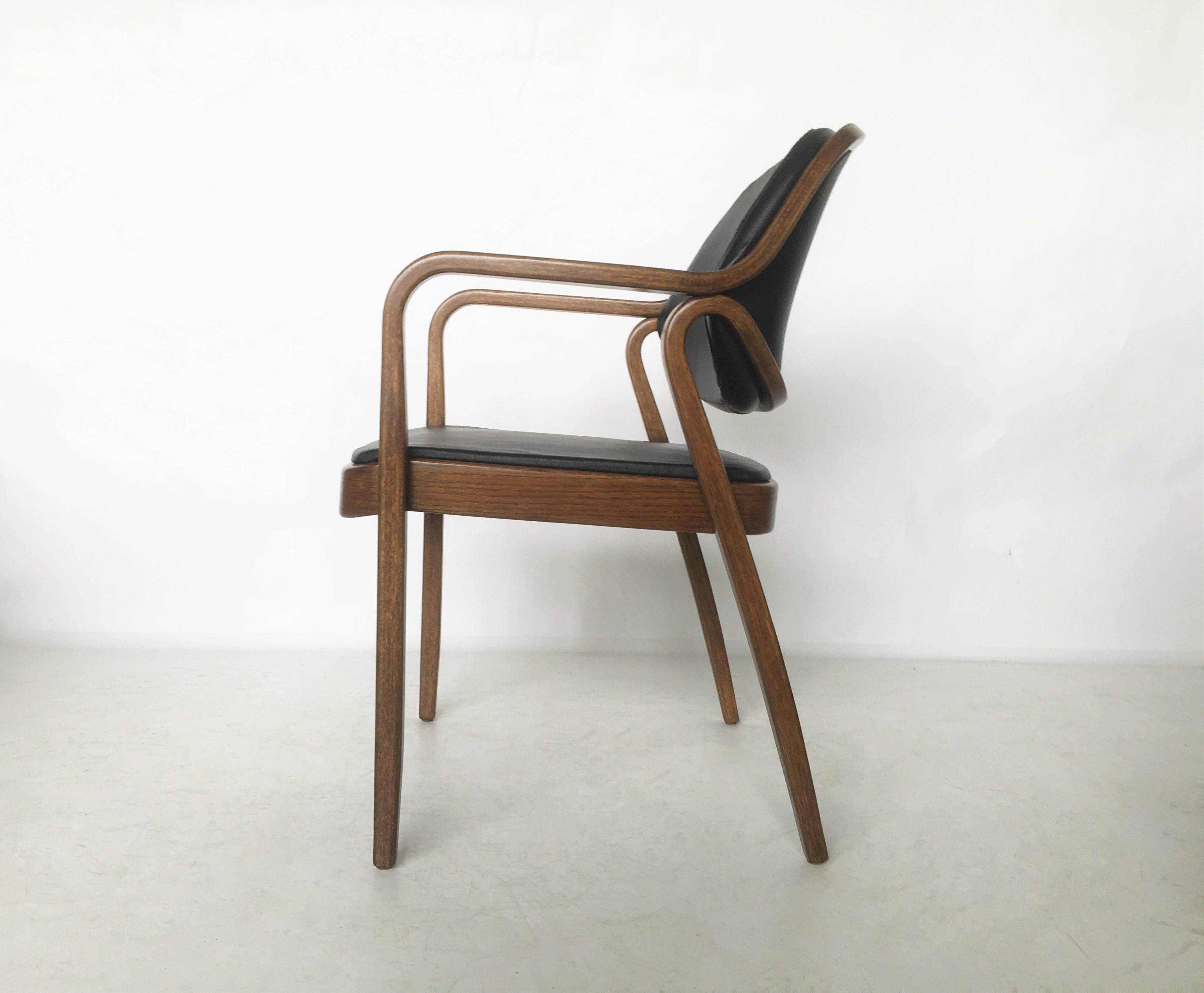 Six bentwood armchairs model #1105 by Don Petitt for Knoll. Two lengths of pressed and bent layers of sculpted wood make up the legs and arms as well as the seat back frames. Restored, the chairs feature black leather upholstery that compliments the