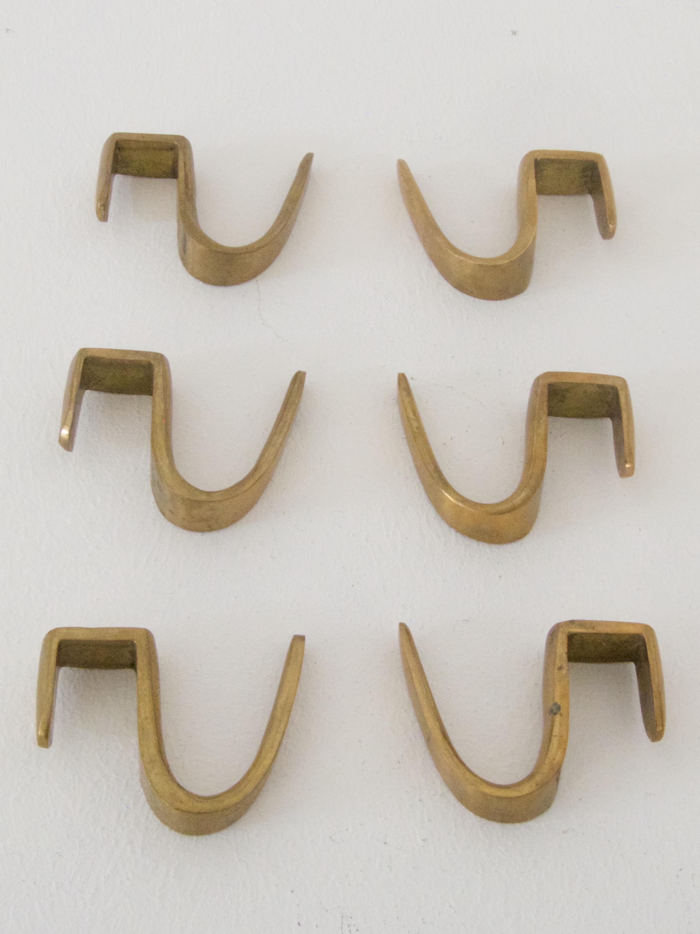 Six vintage brass coat hooks 
designed in the 1960s by C. Auboeck

Additional hooks for the Carl Auböck coat rack.

Nice patina!