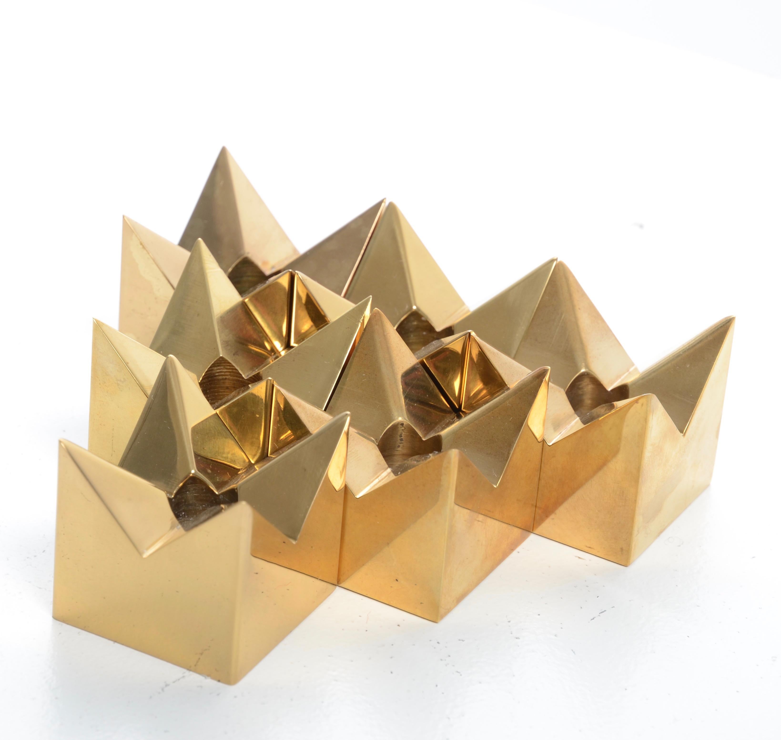 Six candleholders, brass stars, designed by Pierre Forssell for Skultuna, Sweden, 1960s.

Bottom with maker's mark and signature.