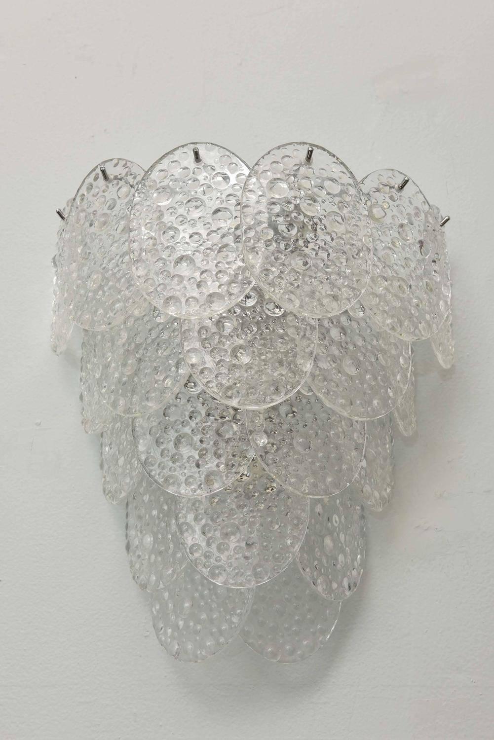 Vintage Italian wall lights with circular clear Murano glasses hand blown with bubbled textured pattern, mounted on chrome frames / Designed by Mazzega, circa 1960s / Made in Italy
2 lights / E12 or E14 type / max 40W each
Measures: Height 12