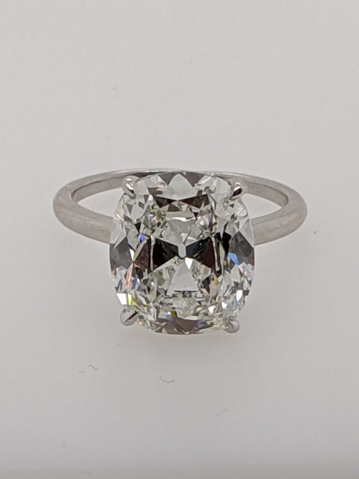 Six carat Classic Antique Style Cushion Cut Diamond Ring in a temporary Platinum Solitaire mounting (which is included with this diamond free of charge or good toward a custom made mounting).  This extraordinary featured diamond is a 6.16 carat H