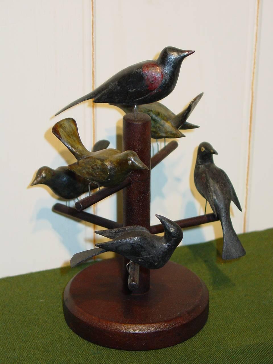 Six charming carved and polychrome-decorated pine songbirds mounted on a contemporary tree. The birds, made circa 1900 by the Gottschall Family, Lebanon County, Southeastern Pennsylvania, were originally part of a large group of birds and Noah's Ark
