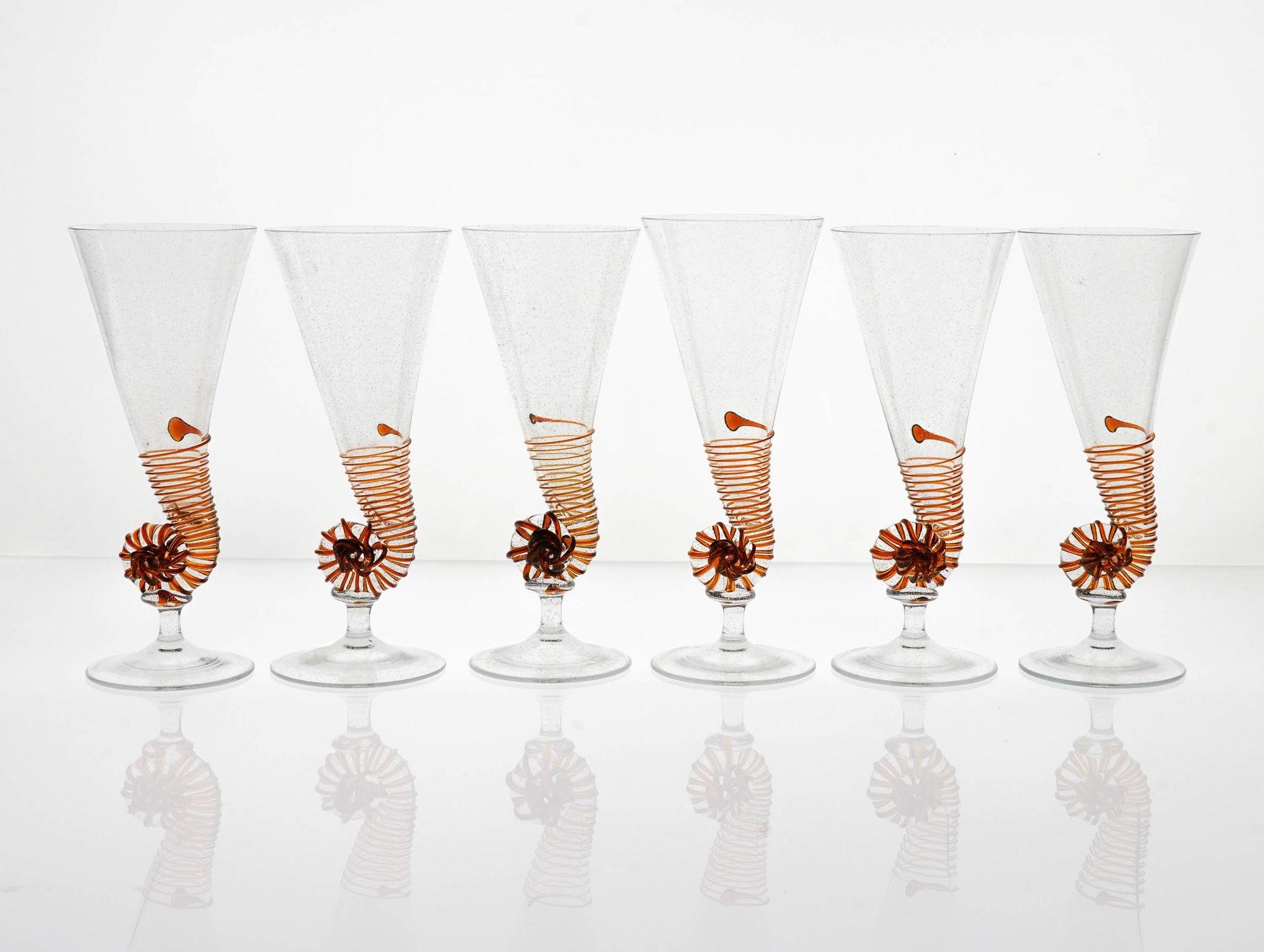 Introducing this rare and exceptional set of antique Murano glass flutes, inspired by the nautilus shell.

These unique and handcrafted flutes are a masterpiece of craftsmanship, made in the 1950s by Cenedese, one of the most renowned glassmakers of