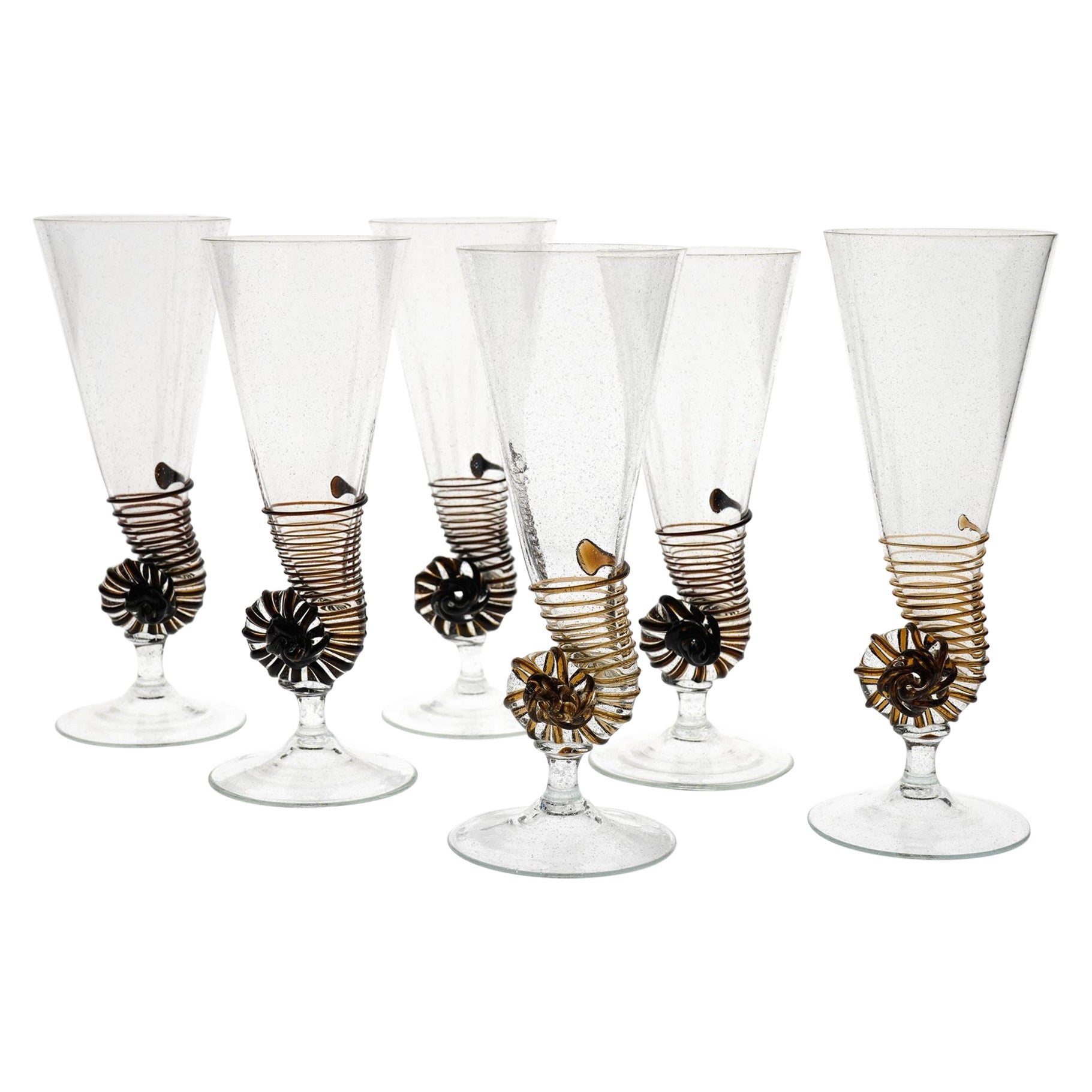 Introducing the Nautilus Shell Inspired Murano Glass Flutes
This unique and rare set of flutes is a must-have for any collector of vintage glass. Made in Murano in the 1950s by Cenedese, one of the most renowned glassmakers of the time, these flutes