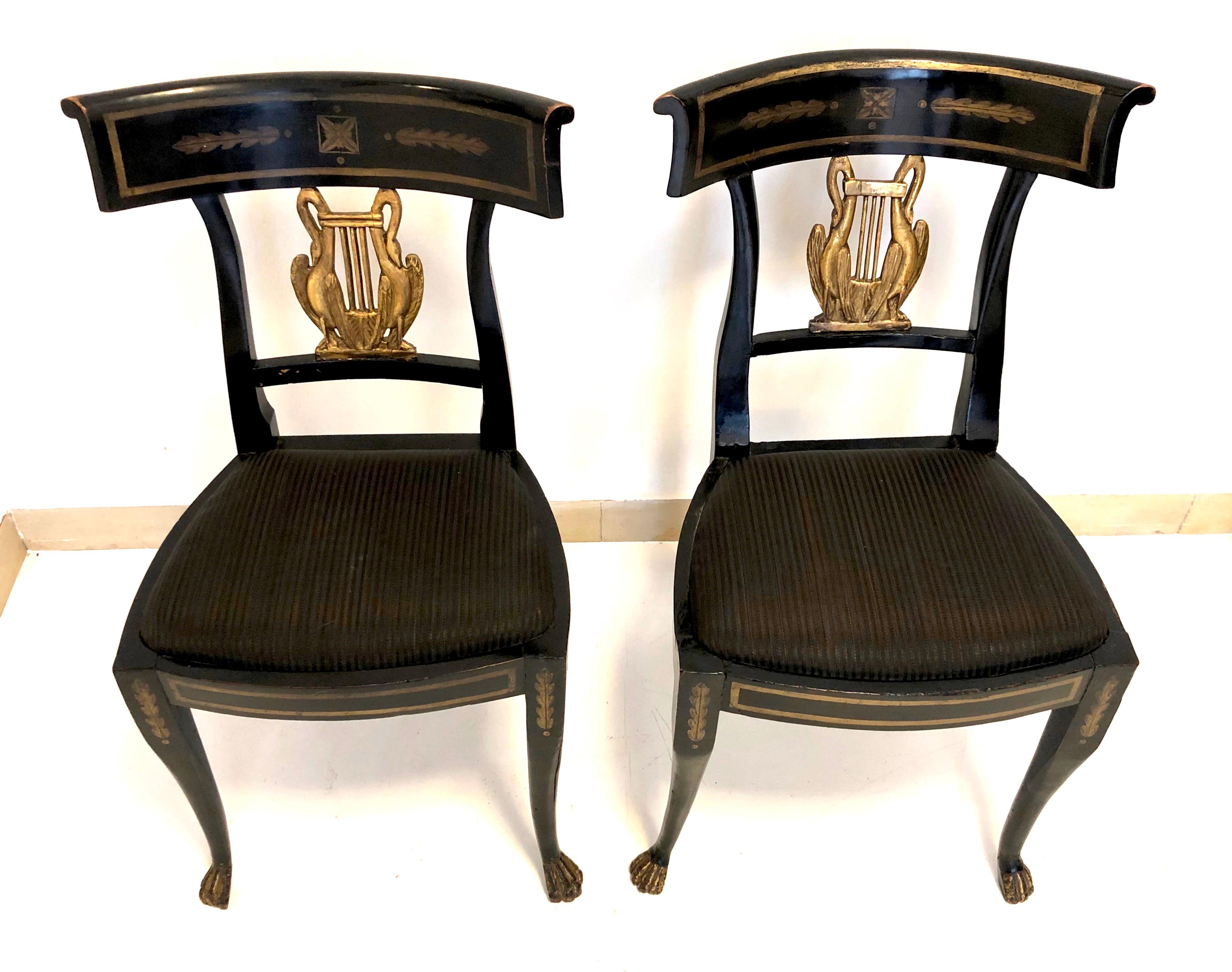 An extremely rare set of six Empire chairs, made out of ebonized beechwood in Italy-Lucca, circa 1815, at the time when the sister of Napoleon was Duchess of Tuscany. The front legs are slightly curved and terminate in carved lion paws.The chair