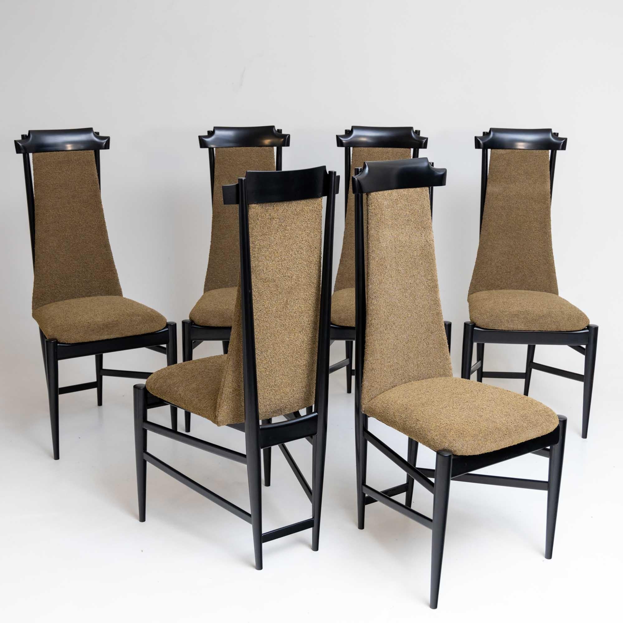 Set of six dining chairs designed by Sergio Rodrigues (Brazil, 1927-2014) in the 1960s. The chairs have an elegant, ebonized frame with high backrests and trapezoidal seats. The chairs have been polished and reupholstered with olive green bouclé.