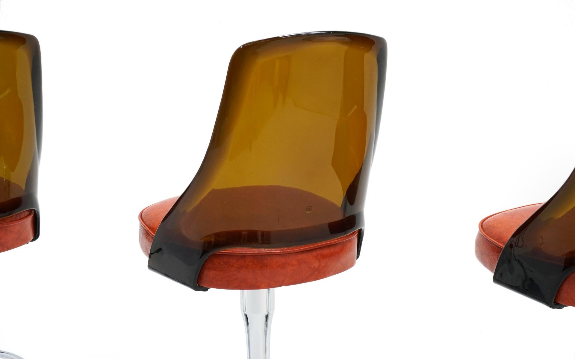 Mid-Century Modern TWO AVAILABLE. of Chrome and Amber Lucite Bar Stools with Orange Vinyl Seats.
