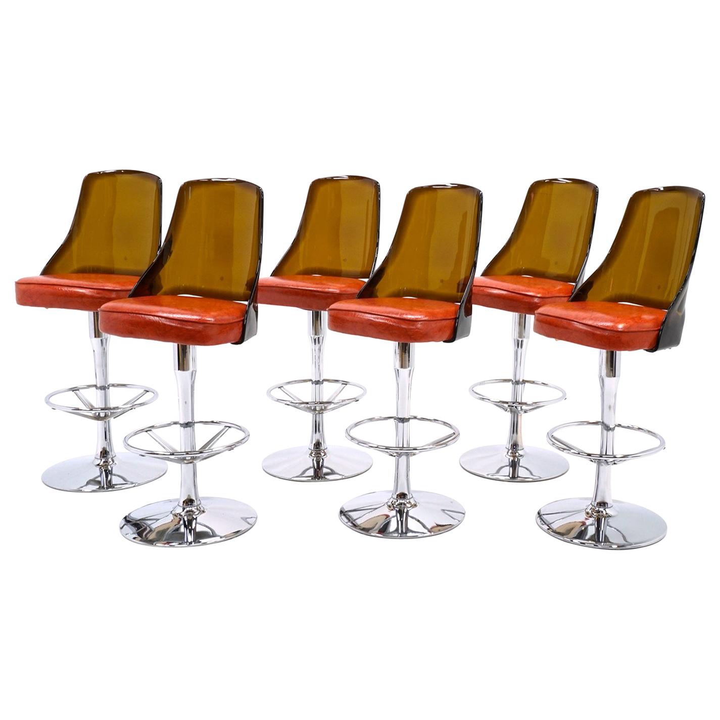 TWO AVAILABLE. of Chrome and Amber Lucite Bar Stools with Orange Vinyl Seats.