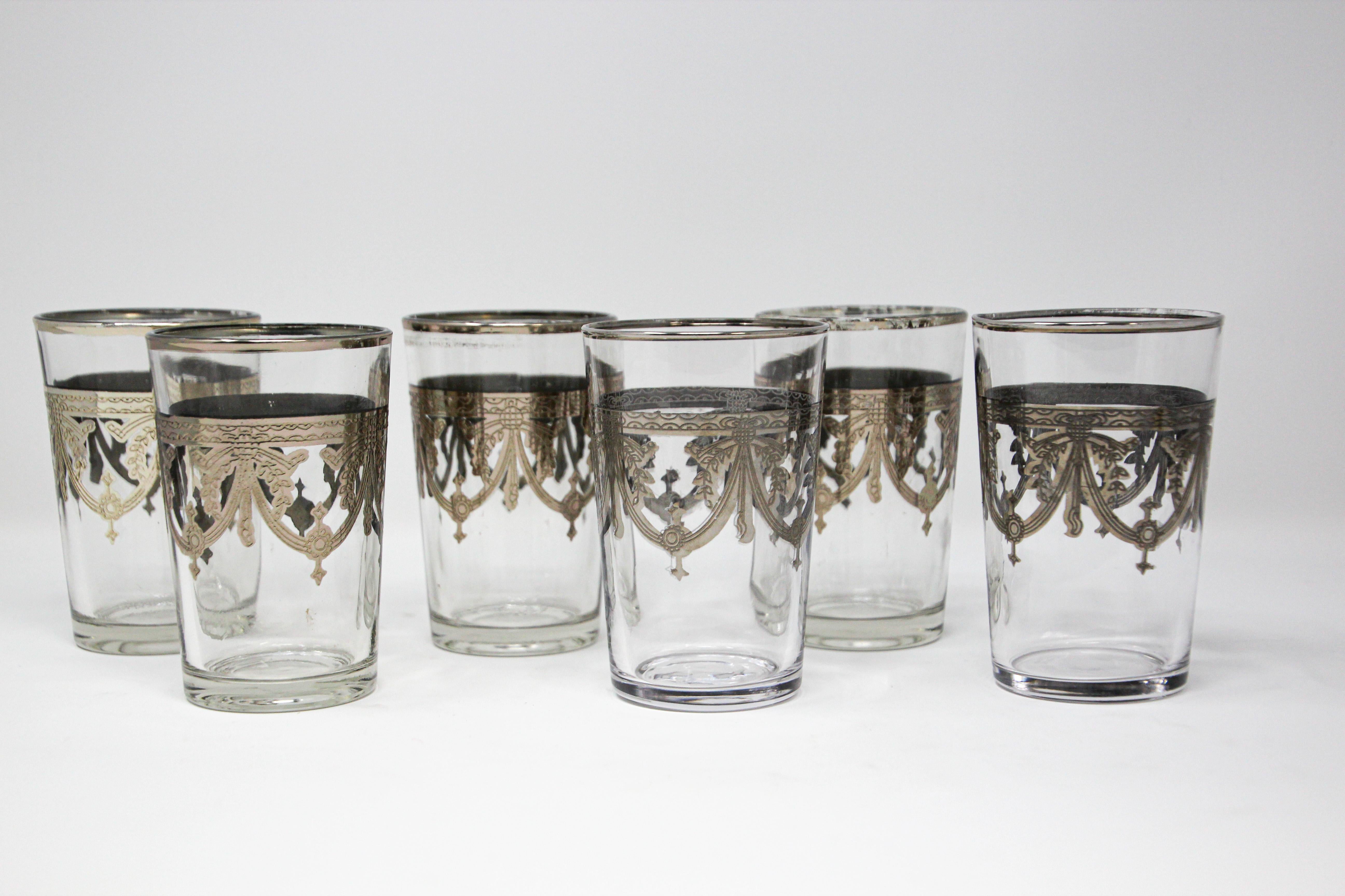 Moroccan Glasses Set of Six Clear with Silver Overlay Moorish Pattern.
Set of six small shot glasses in clear and silver overlay with a Moorish arabesque design.
The Moroccan tea or shot glasses are decorated with a classical silver pattern overlay