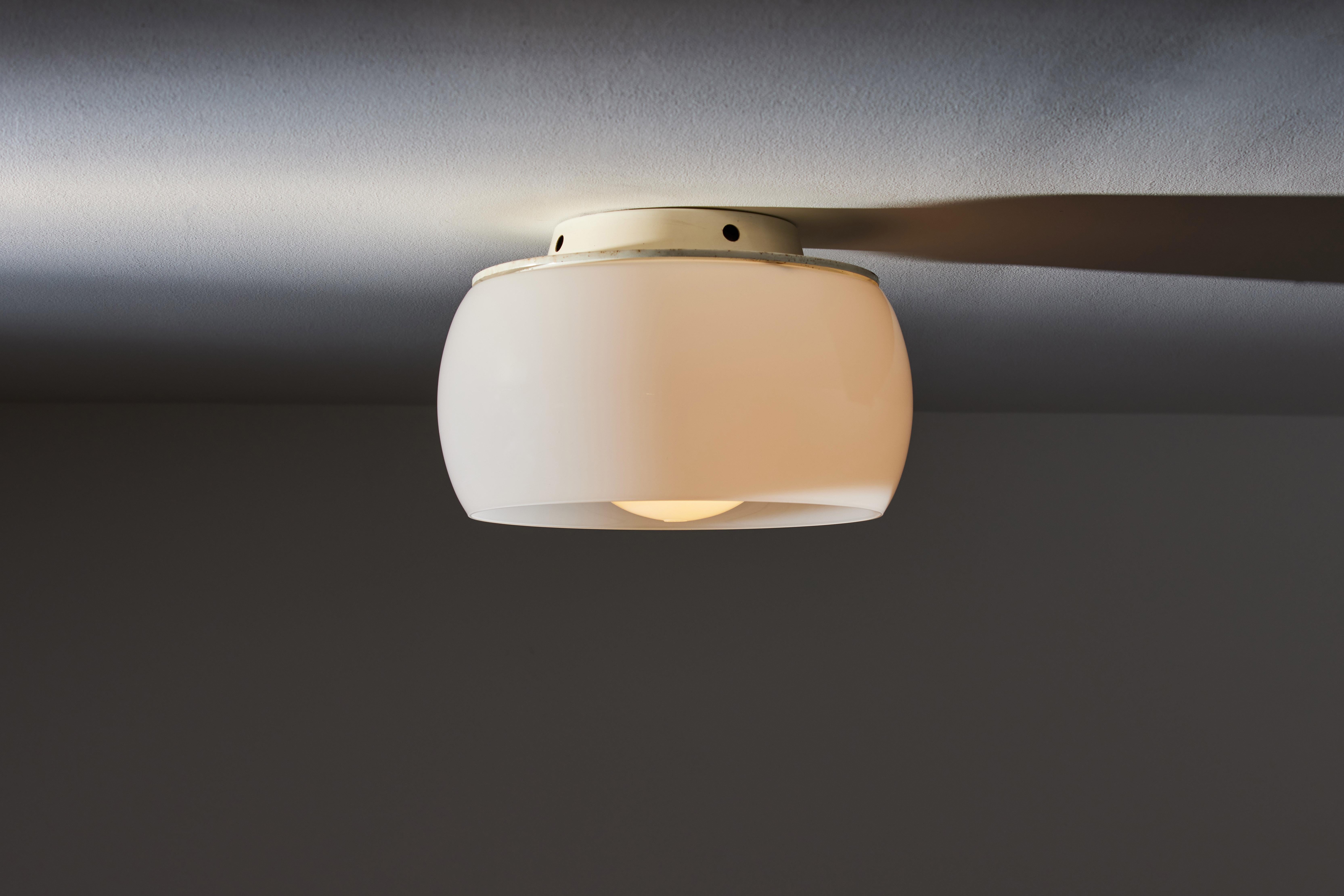 Clinio Flush Mount Ceiling Light by Vico Magistretti for Artemide. Designed and manufactured in Italy circa 1960's. Opaline glass diffusers .Enameled metal frame. Rewired for U.S. standards. We recommend one E27 100w maximum bulb per fixture. Bulbs