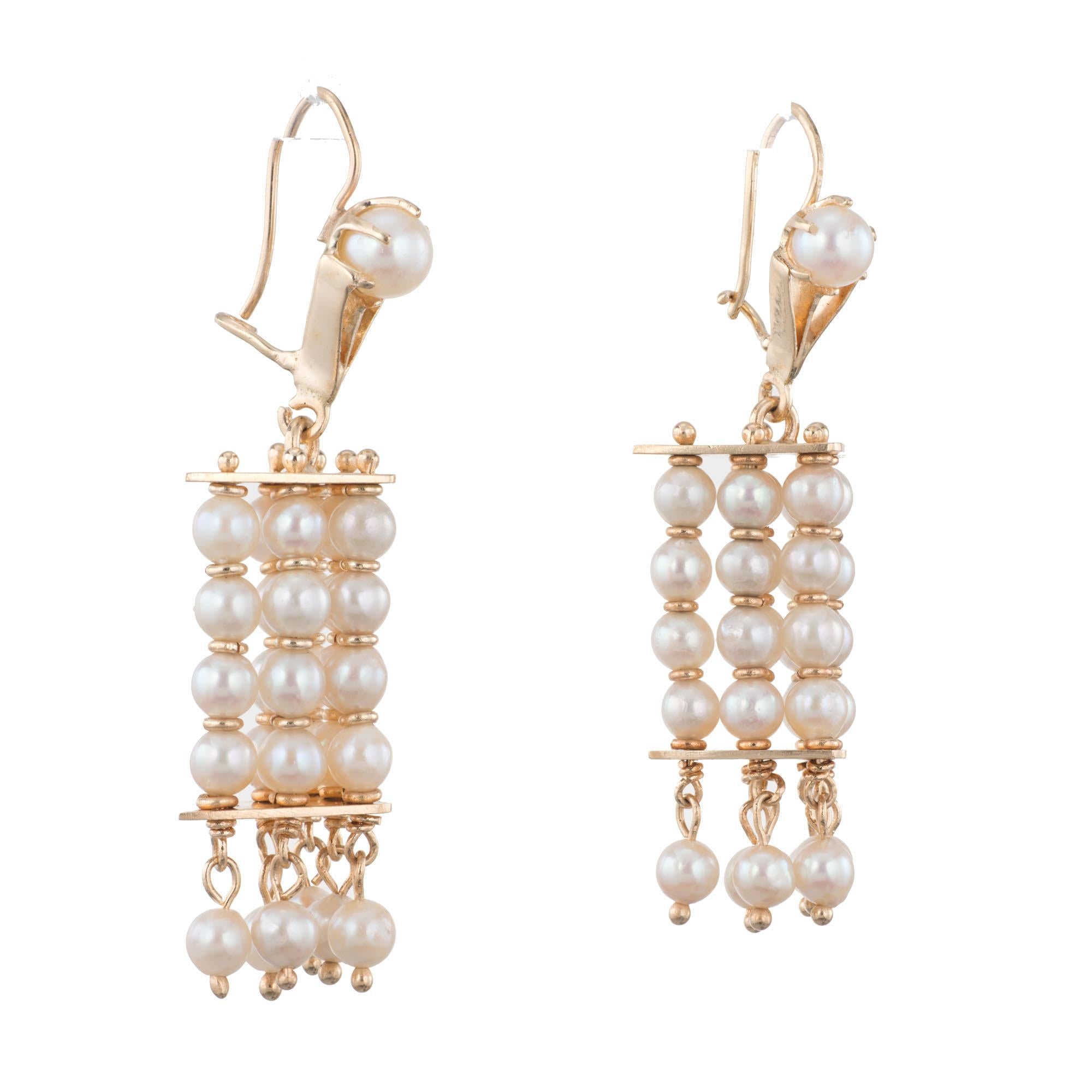3-D cultured pearl dangle earrings, with 6 columns of pearls in a triangle shape. Wire top and pearl dangle bottom. 14k yellow gold.  Circa 1950's.

2 cultured pearls 5mm
60 cultured pearls 3.7mm
14k Yellow Gold
Tested: 14k
Stamped: 14k
11.8