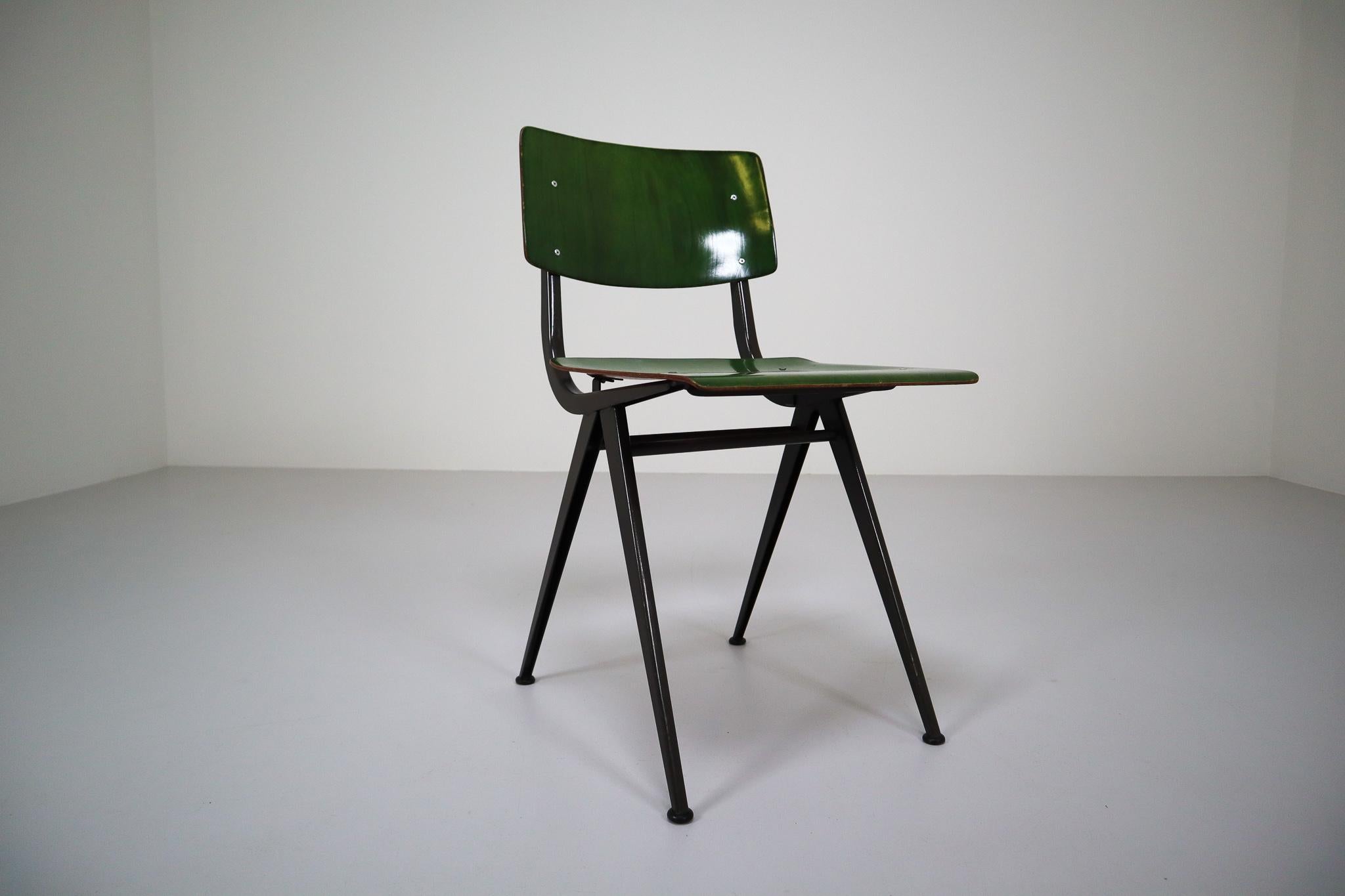 Very nice set of six compass shaped Industrial chairs manufactured by Marko Holland, 1960s. Close to the designs by Friso Kramer and the quality is also very close. Nicely shaped chairs with black U-structural frame and green / cognac pagwood seat