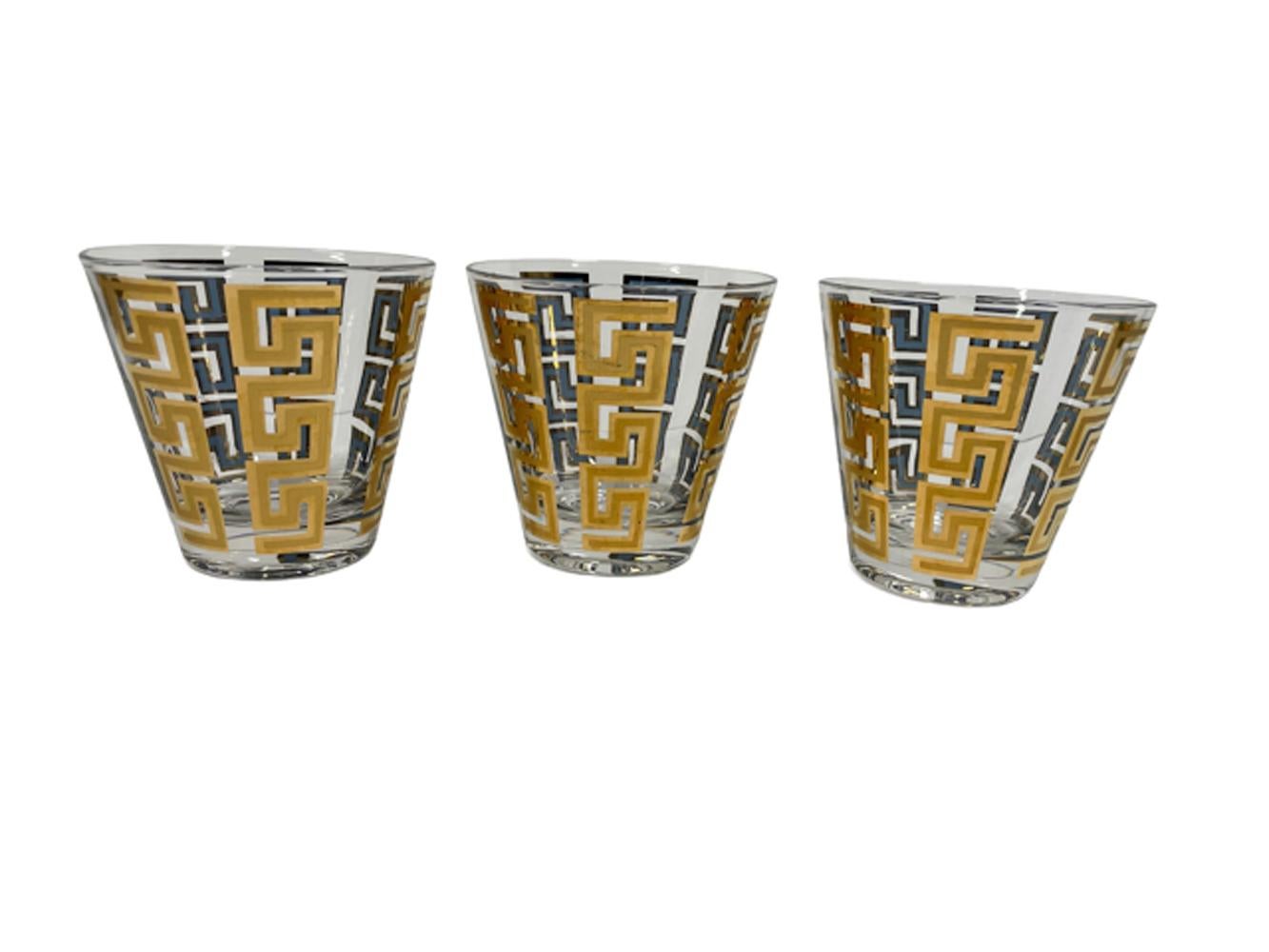 Six Culver, LTD. old fashioned glasses with tapered sides having vertical Greek Key bands of 22k gold over blue enamel. The gold with satin finish within gloss on the exterior with the blue visible only on the interior with gold border.