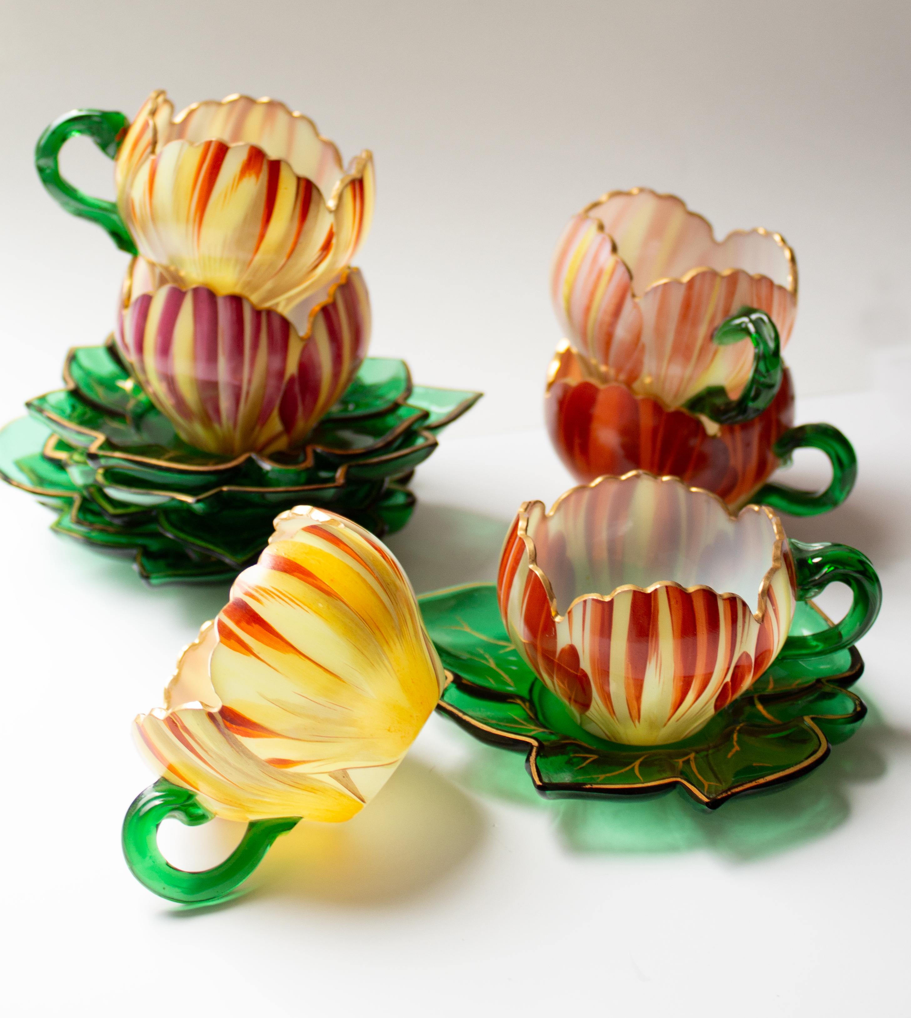 An exceedingly rare set of six cups with saucers, whose beauty captures both the eye and the imagination. The hand-blown opaline glass cups are shaped as delicate tulip blossoms, their charm enhanced with finely hand-painted enamel decoration. Each