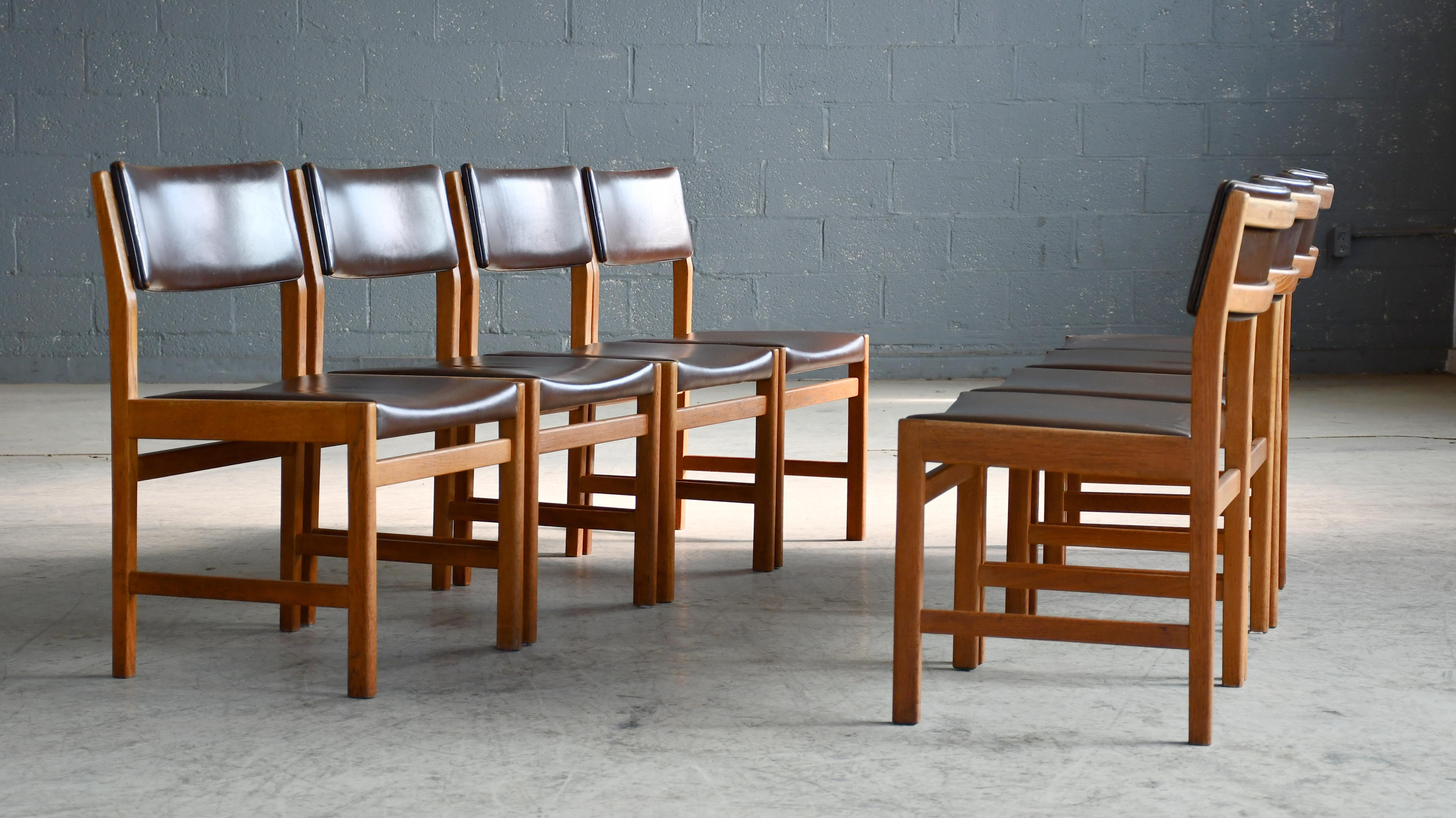 Set of 7 dining chairs designed by Kurt Østervig for KP Mobler in the 1960's. Solid Oak and a dark brown leather on the seat and backrests. The oak has taken on a nice warm tone - almost teak like. The leather is still supple and not showing a lot