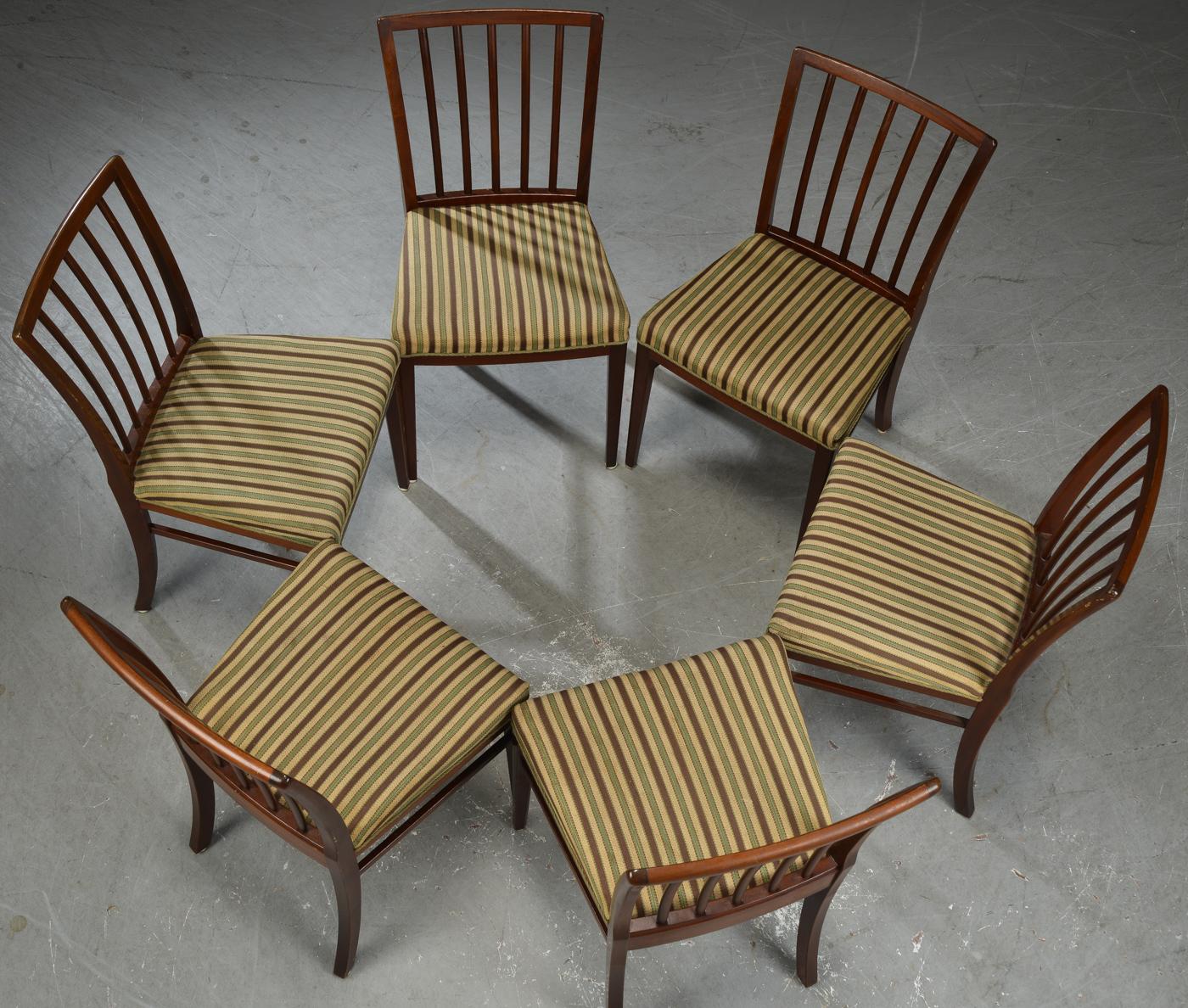 Set of six Danish modern dining or side chairs with mahogany frames. Elegant and comfortable curved and slatted backs. Seats upholstered in striped beige, brown and green wool.