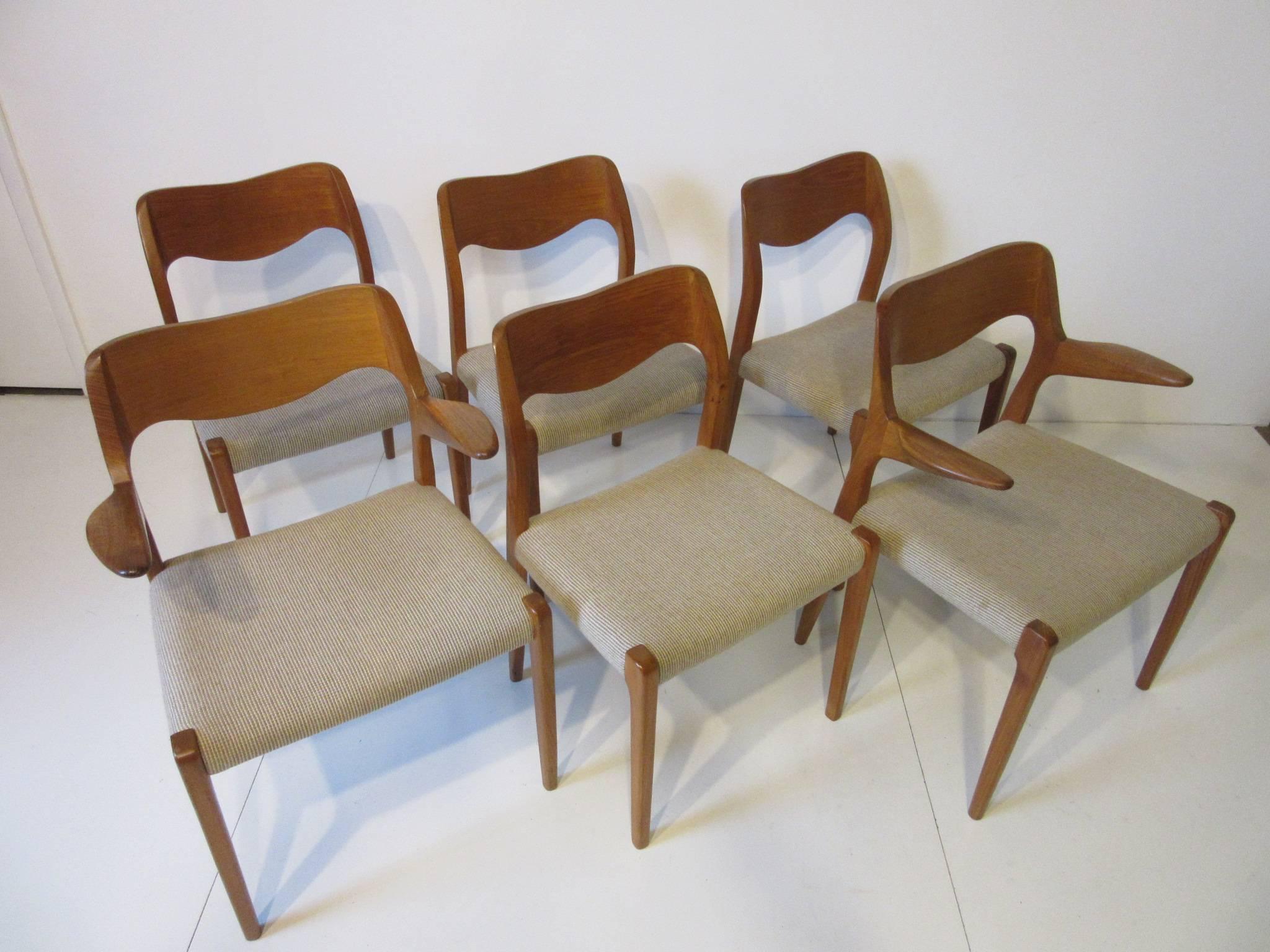 A set of six sculptural teak wood dining chairs four sides and two armchairs with upholstered seats. Comfortable and stylish they fit with almost any decor, retains the original labels and branded manufactures mark crafted by Hojbjerg Mobler made in