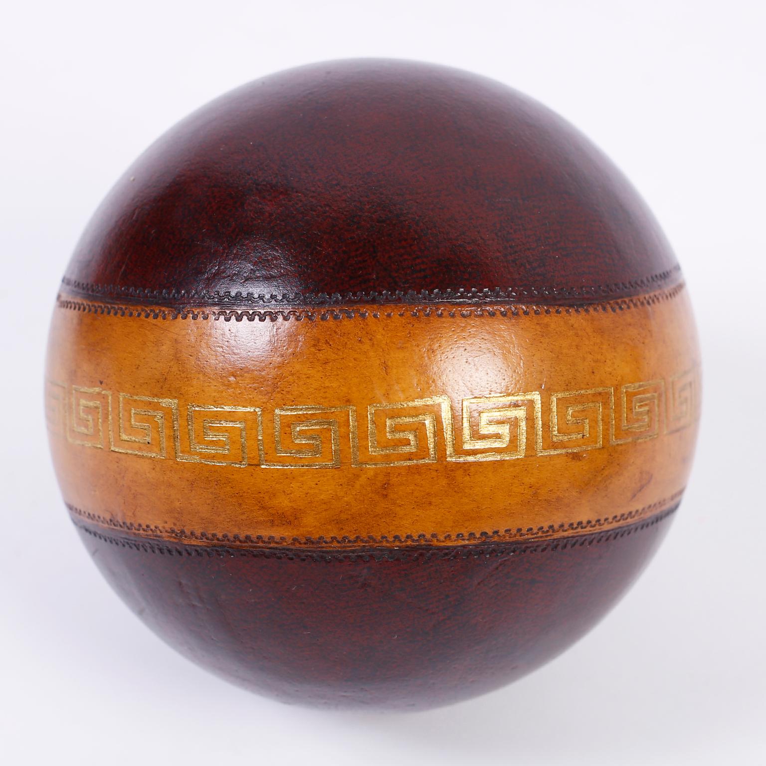 Intriguing set of six decorative bocce or lawn balls with a variety of colors and patterns, featuring embossed gold leaf decorations including Greek key and fleur de lis.