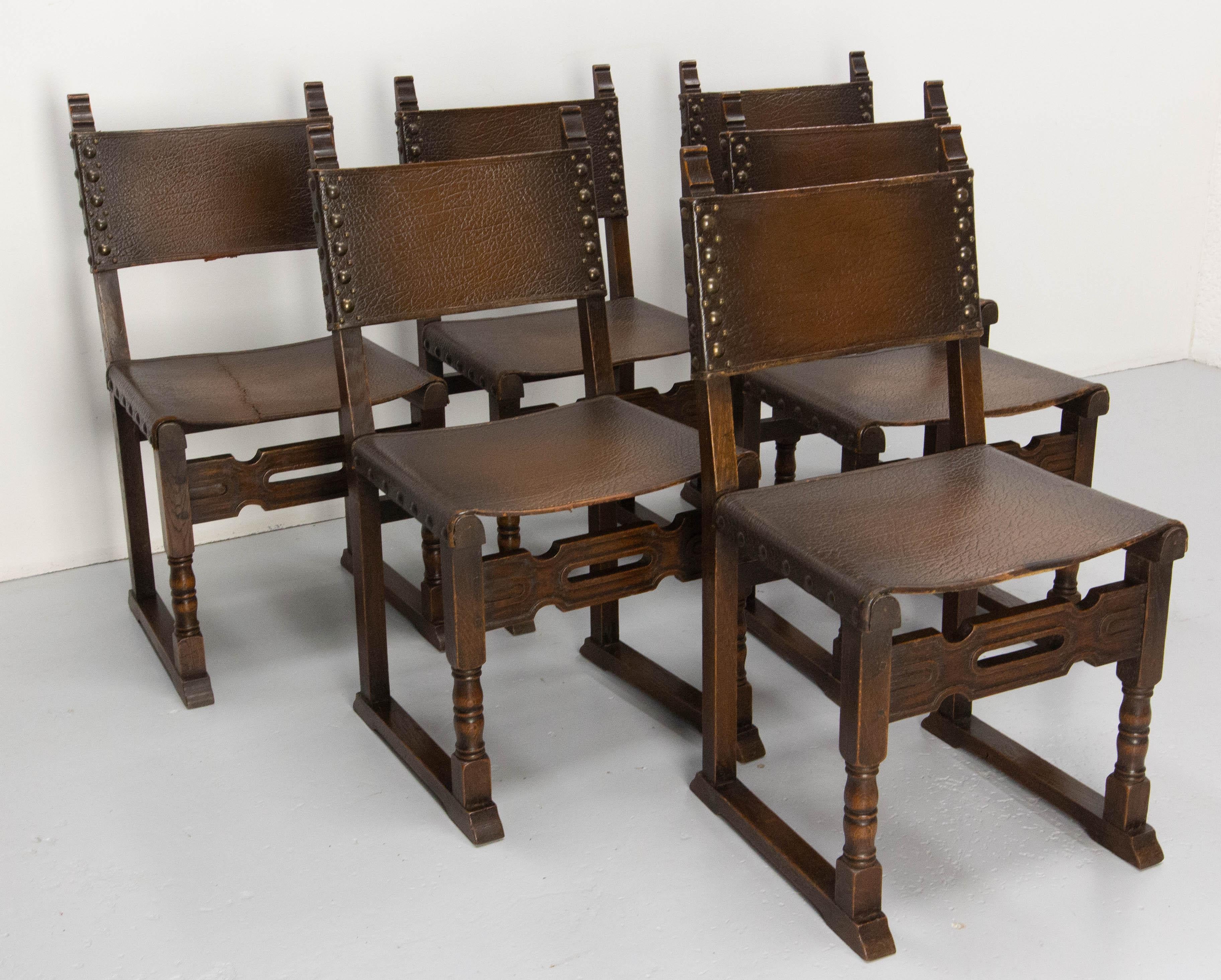 Handsome set of six chairs
Chestnut, leather and iron studs.
The leather seats are all reinforced with upholsterer's straps. The leather covering one of the chairs was torn, so straps were added underneath the seat and a seam was sewn for purely