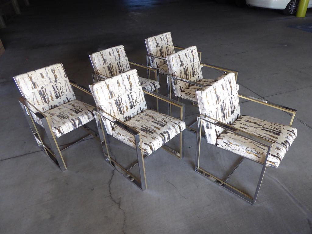 A fabulous set of six dining chairs attributable to Italian designer Romeo Rega, circa 1970s. Polished chrome and satin brass platings distinguish this group of chairs. They are newly reupholstered in a strikingly interesting graphic printed