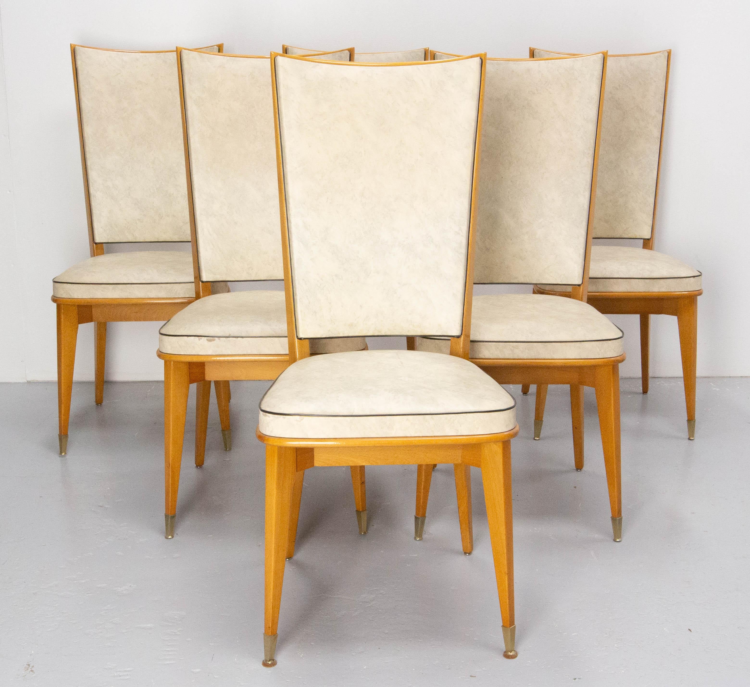 Set of six French dining chairs circa 1950 
Skai and beech. The skai has few stains and can be used has it. You can also recover it if you wish.
The varnish is the original and it is particularly well preserved.
In good condition solid and sound.