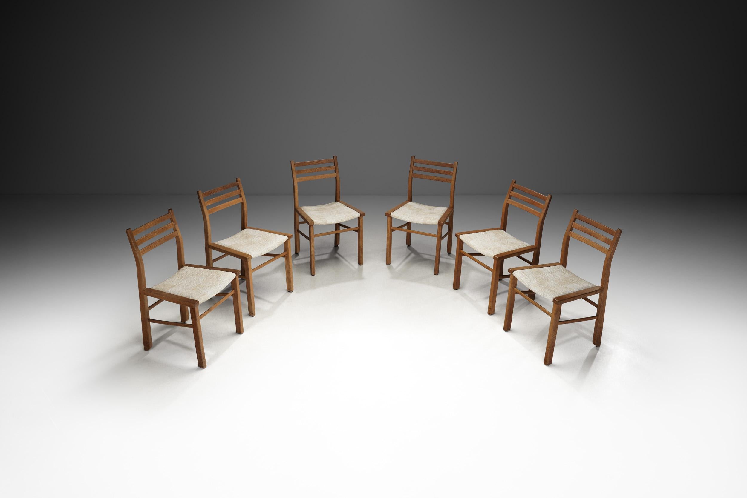 Votre Maison has left an indelible mark on the history of French design with models created by Robert Guillerme along with his partner Jacques Chambron. This set of chairs is a perfect example of the refined craftsmanship produced at Votre Maison by