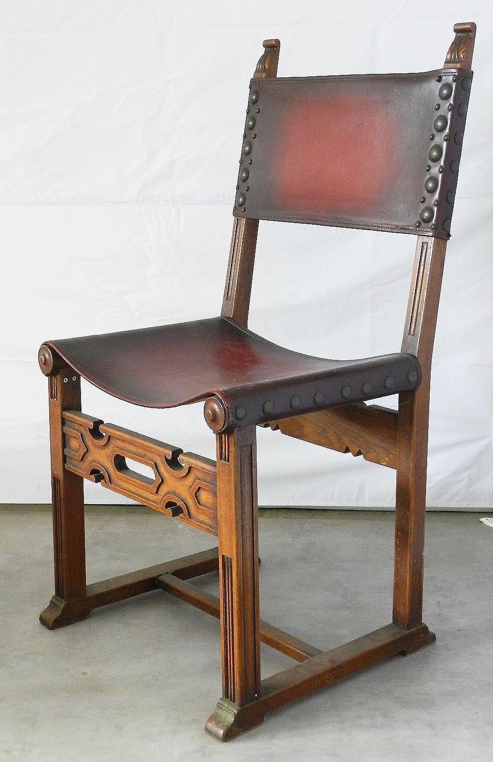 Six Spanish dining chairs leather studs carved wood circa 1920
Spanish French Basque from a house in the Pyrenees
Solid and sturdy set of six chairs
Impressive and comfortable
Red leather with studs 
Leather can easily be changed to suit your