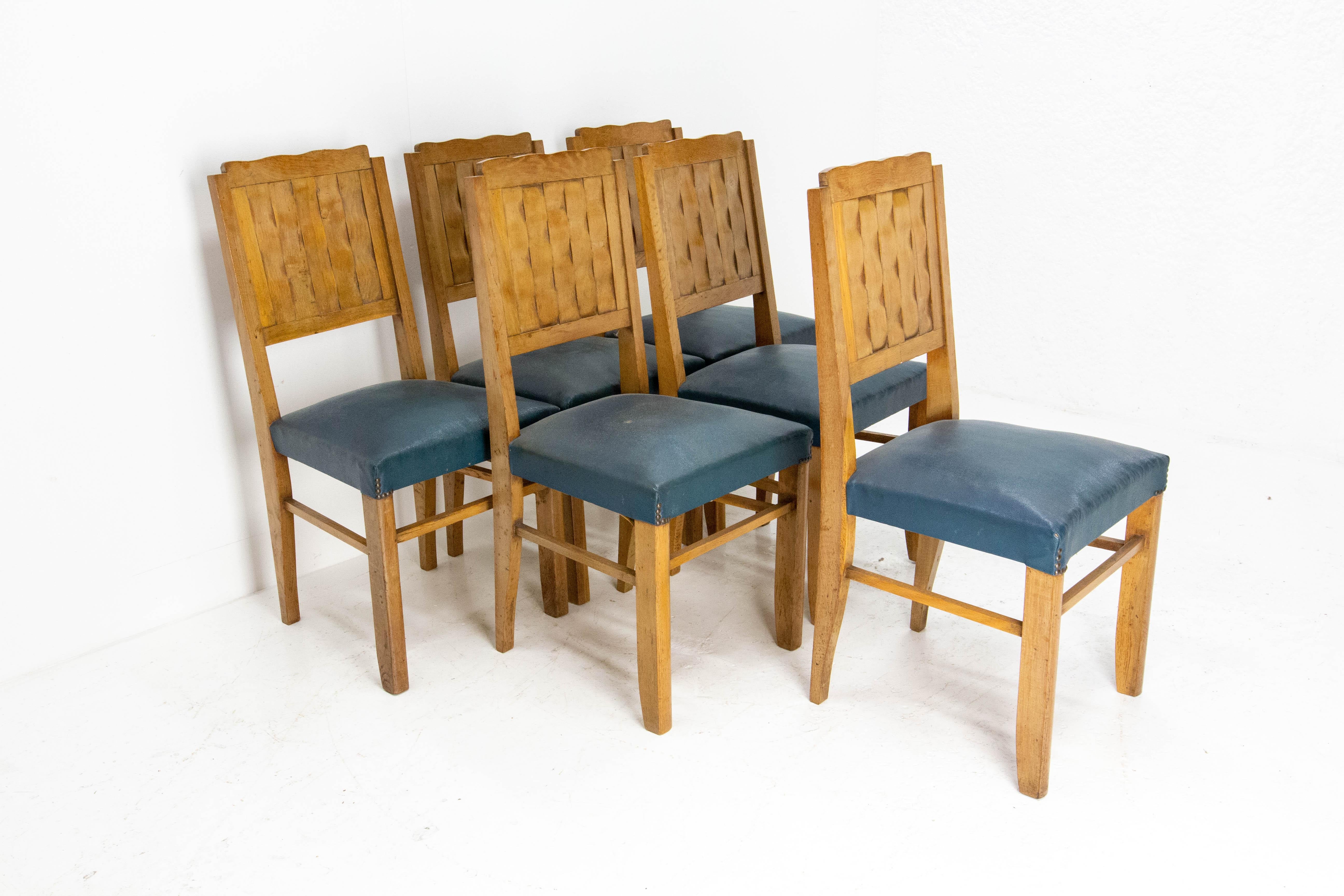 Set of six French dining chairs circa 1950 
Oak 
The backs of the chairs are carved like weaving
In good condition solid and sound to use or easily recovered.

    