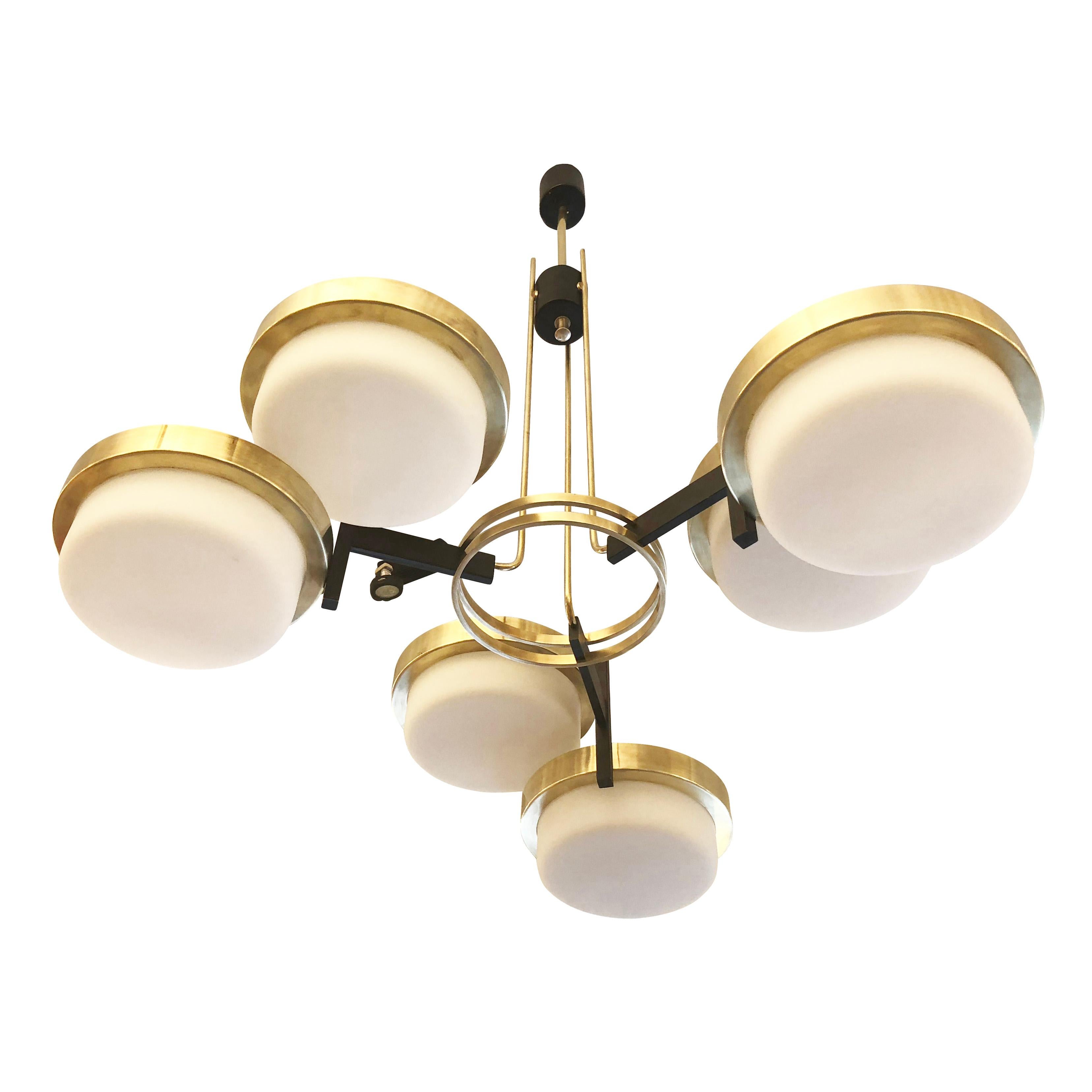 Stunning midcentury fixture attributed to Stilnovo, featuring six shades on a brass and black lacquered frame. Each shade has a brass rim and frosted glass diffuser. Holds one candelabra socket per shade. Drop can be adjusted as