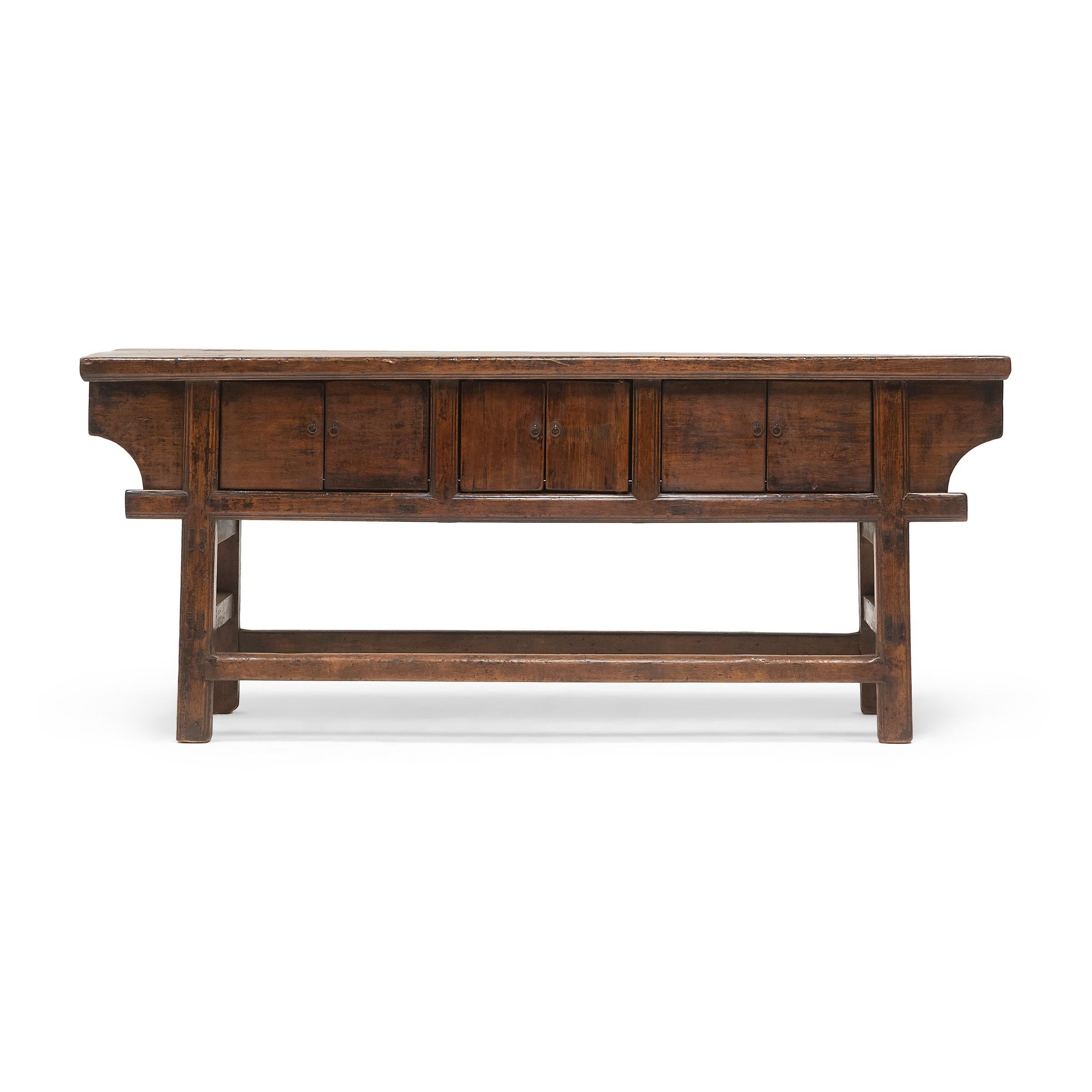 The warm tones and active grain of natural pine wood are the focus of this unusually articulated six-door coffer. Made for a provincial home in northeastern China, this sideboard was once used as a home altar to honor loved ones past and present