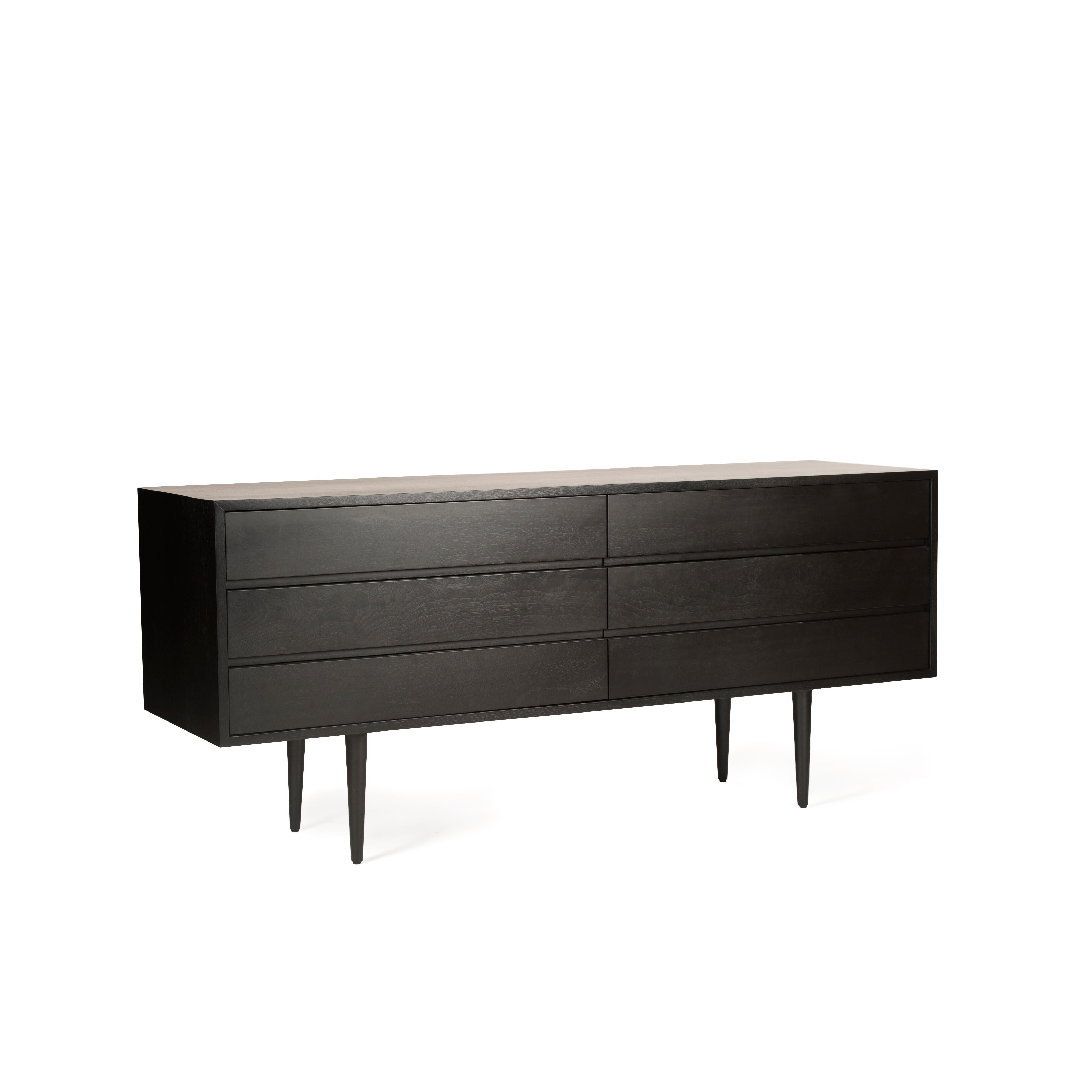Originally designed by Mel Smilow in 1950 and officially reintroduced by his daughter Judy Smilow in 2017, the solid wood Six Drawer Dresser with leather-lined drawers has a beautifully finished front and back in ebonized walnut. The focal point of