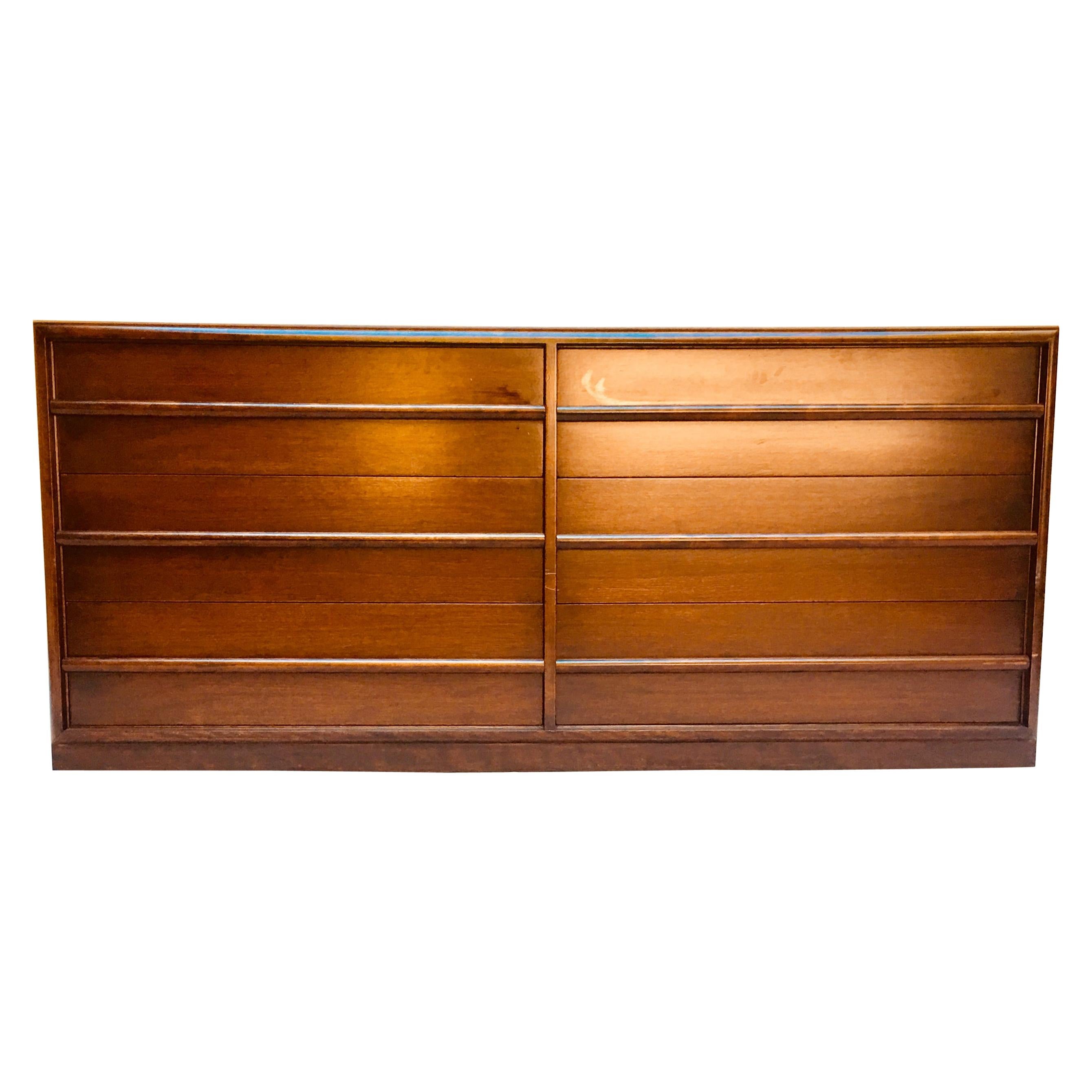 A six-drawer dresser designed by T.H. Robsjohn-Gibbings for Widdicomb, from the 1950s. 
The walnut dresser is in its original Espresso lacquer that has been conserved not refinished and is in excellent vintage condition.
It has its original